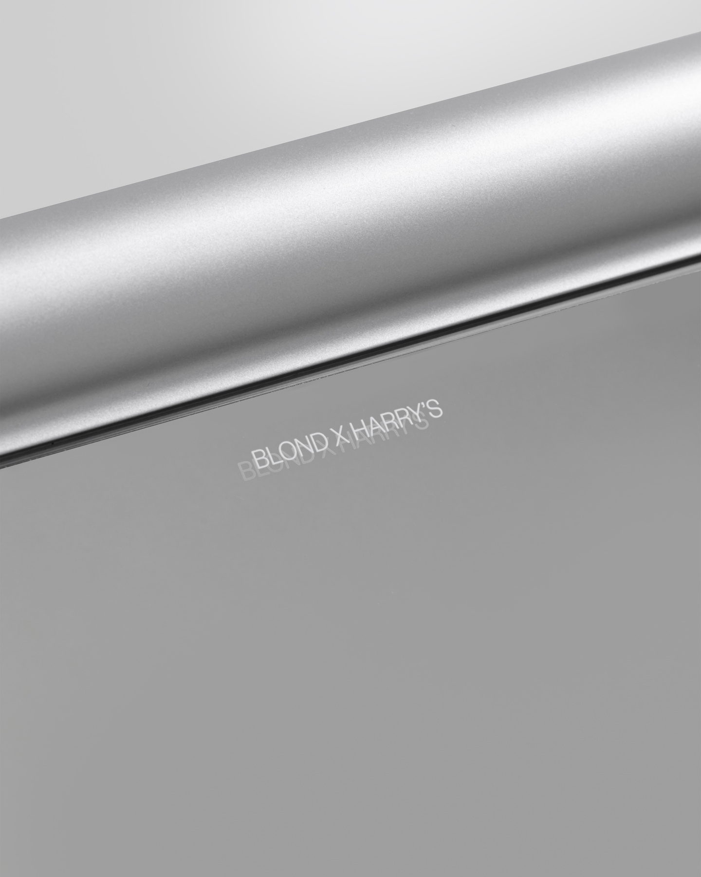 Close-up view of subtle text engraved into a brushed metallic surface