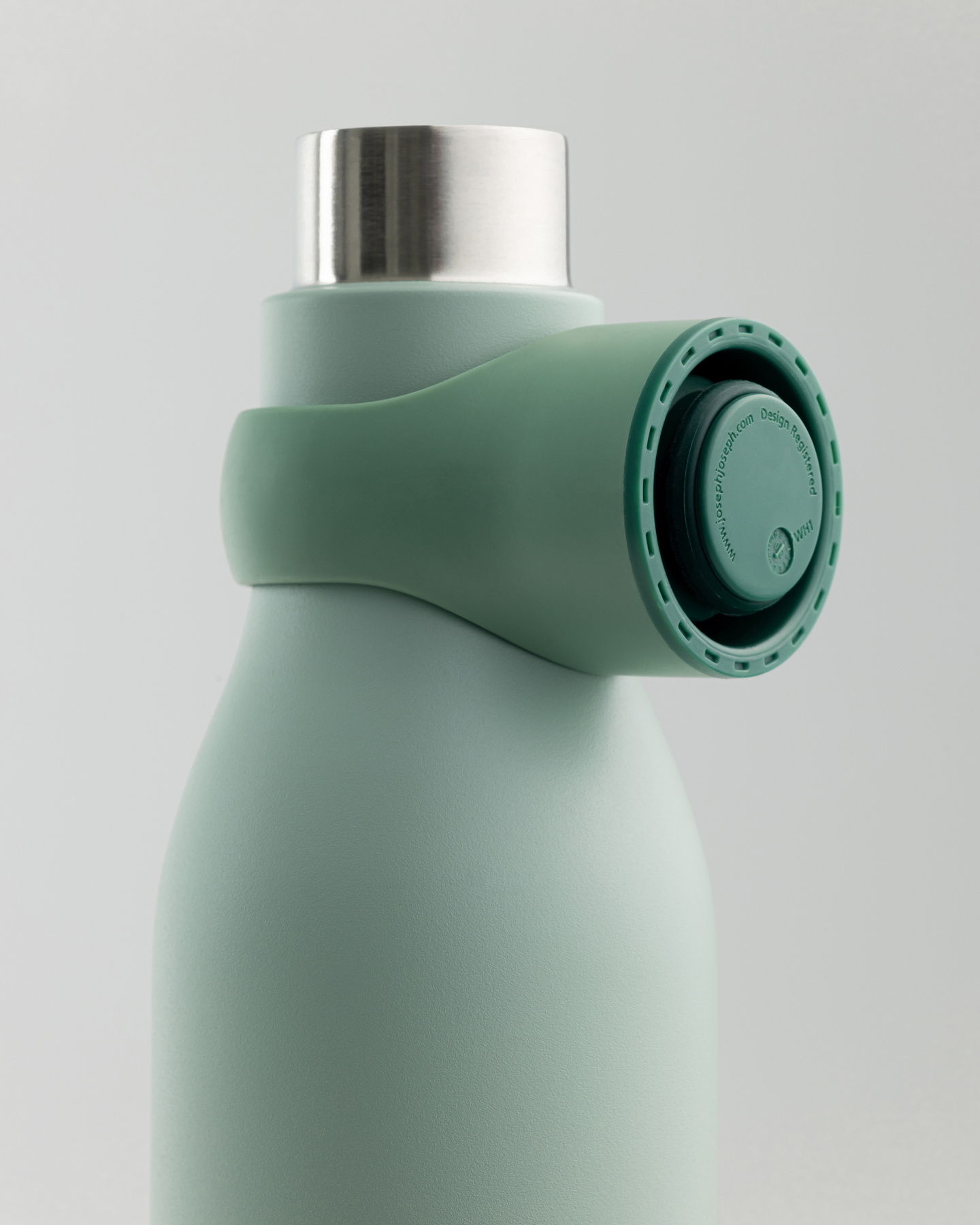 Small inset view of a green water bottle with integrated loop cap