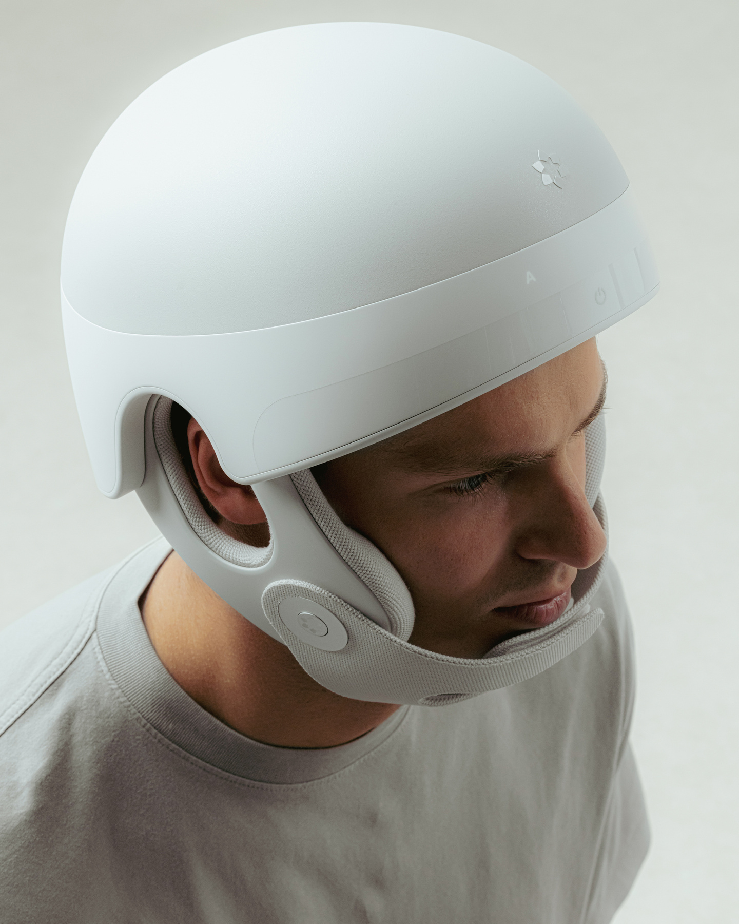 Close-up side profile photograph of a person wearing a white medical headwear device