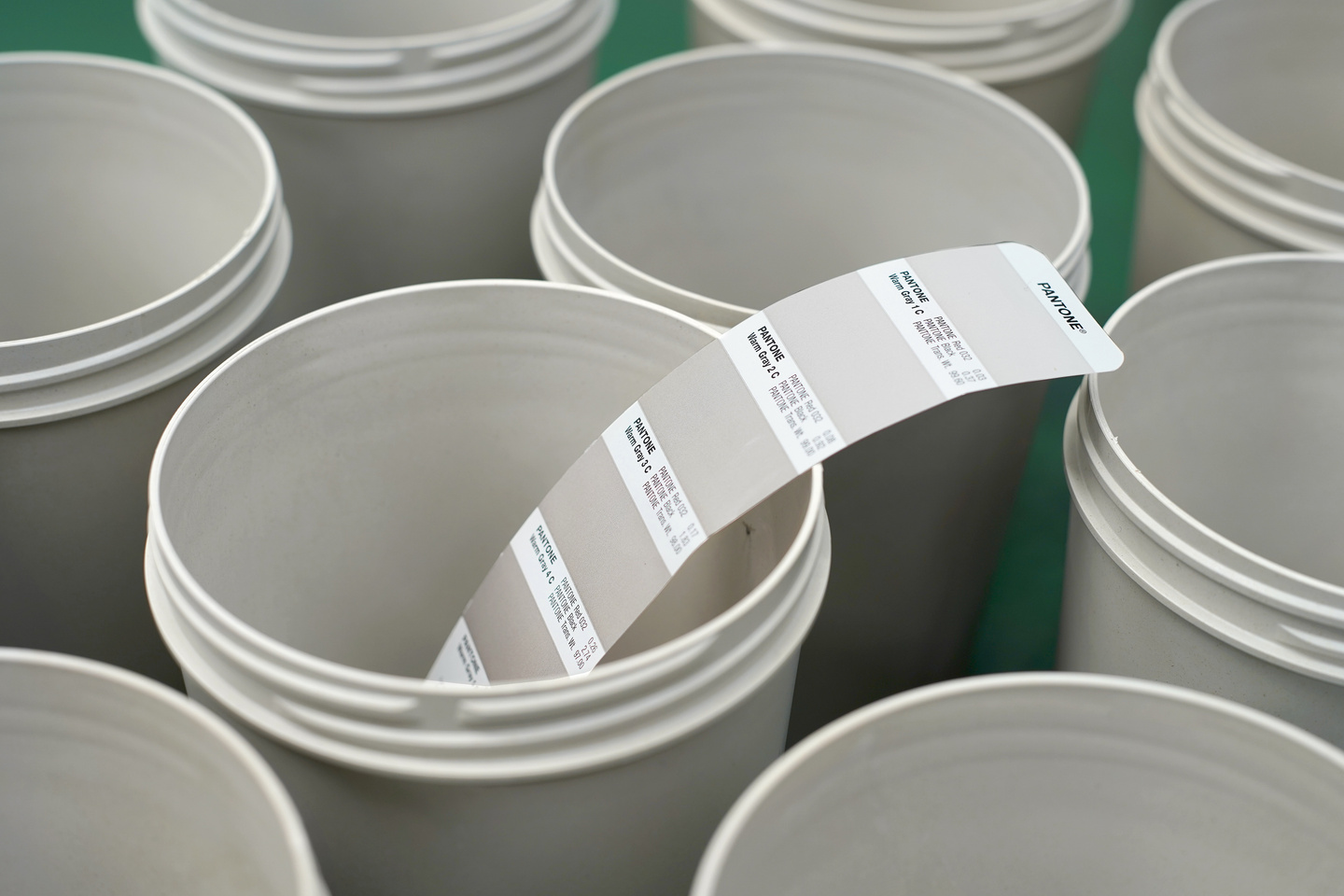 Close-up looking into the opening of stacked white plastic container pots.