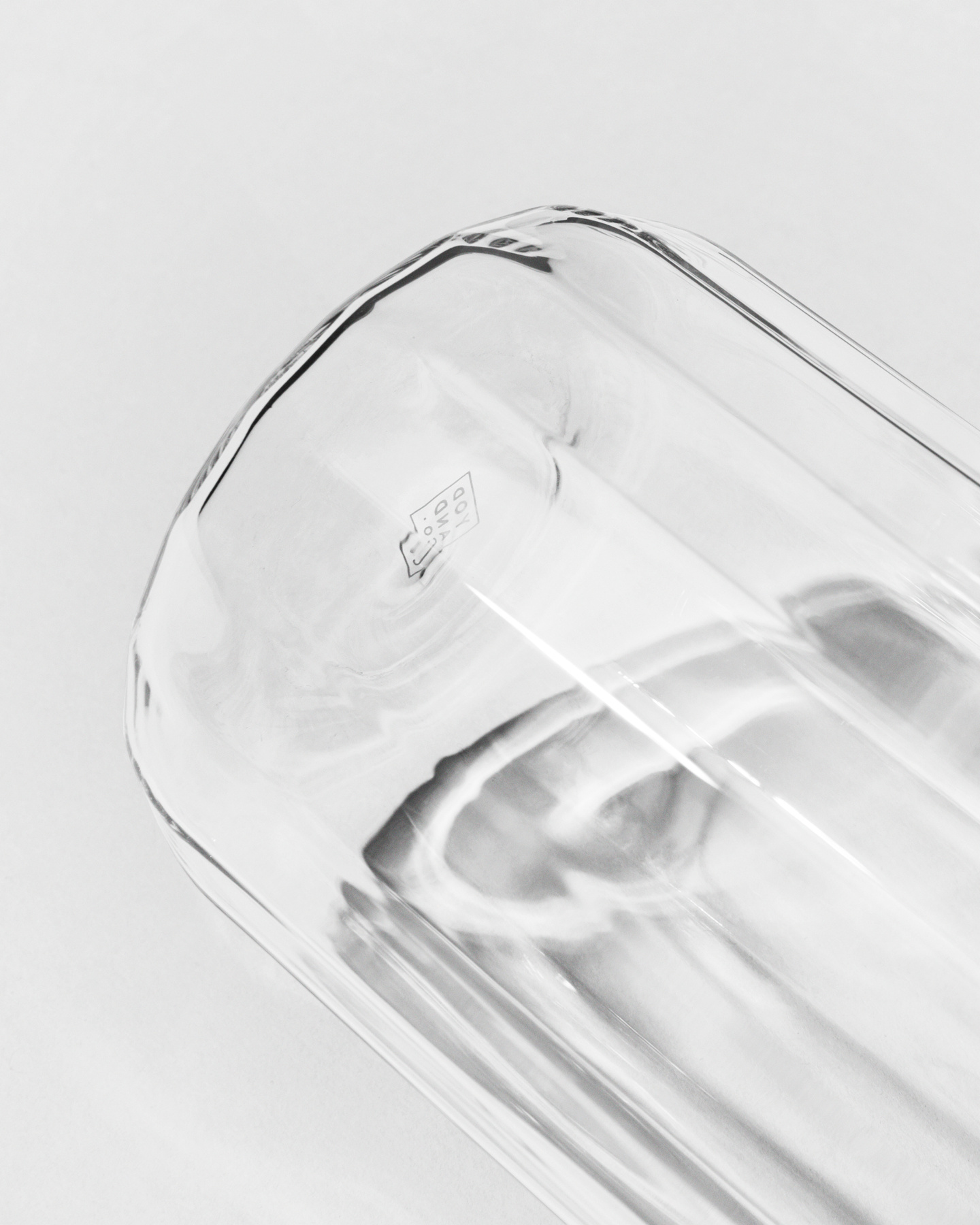 Close-up view showing the faceted base and clear glass texture of a tumbler
