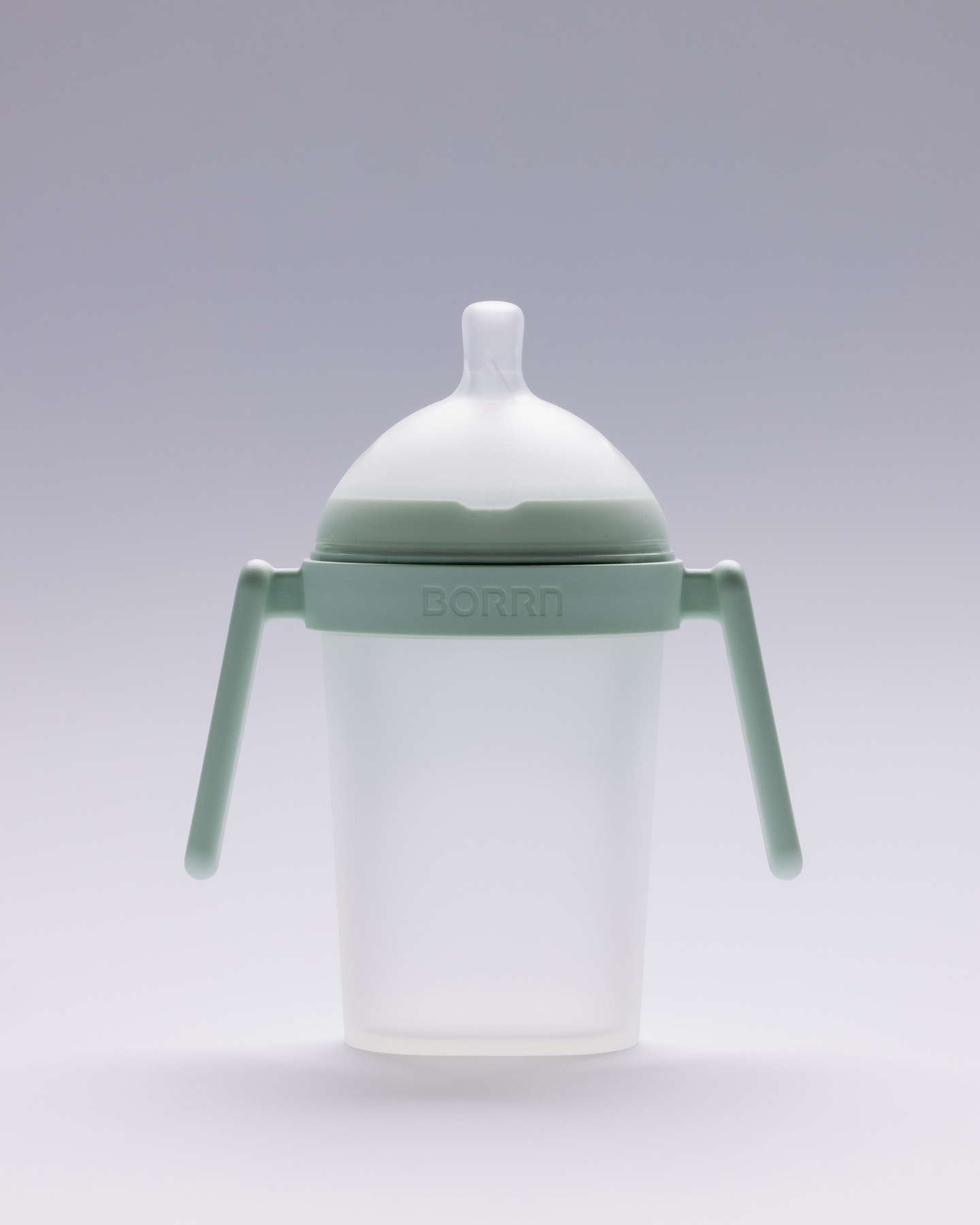White silicone baby feeding bottle with green dual handles.