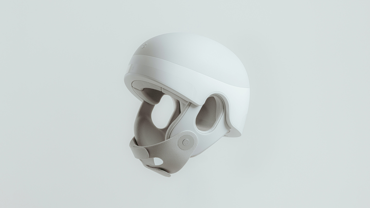 White wearable medical head device studio render against a light grey background