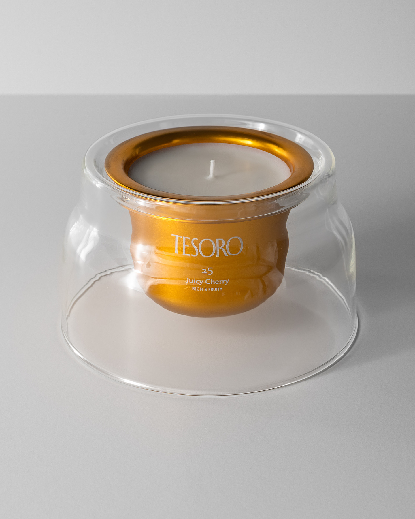 Small view of a glass candle holder with metallic refill insert