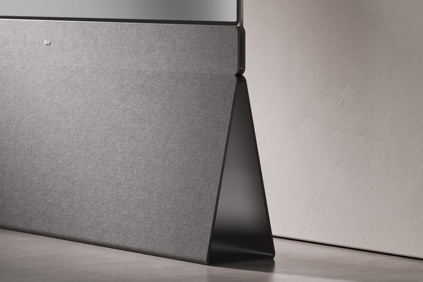 Close-up of textured grey fabric speaker covering.