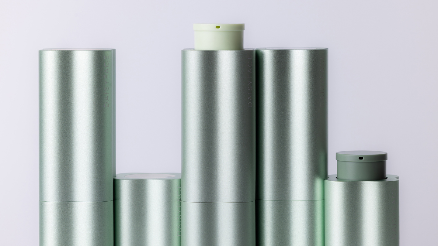 Row of green fluted skincare bottle caps and pump tops
