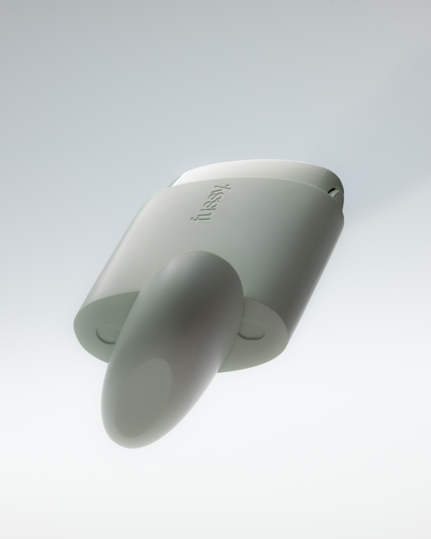 Bottom perspective view of a mint green Fussy refillable deodorant case.