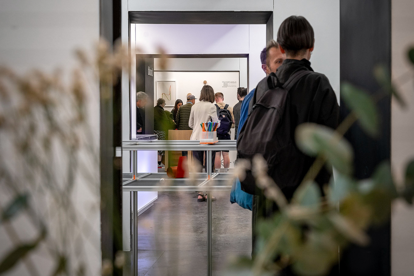 View of visitors chatting in the exhibition space.