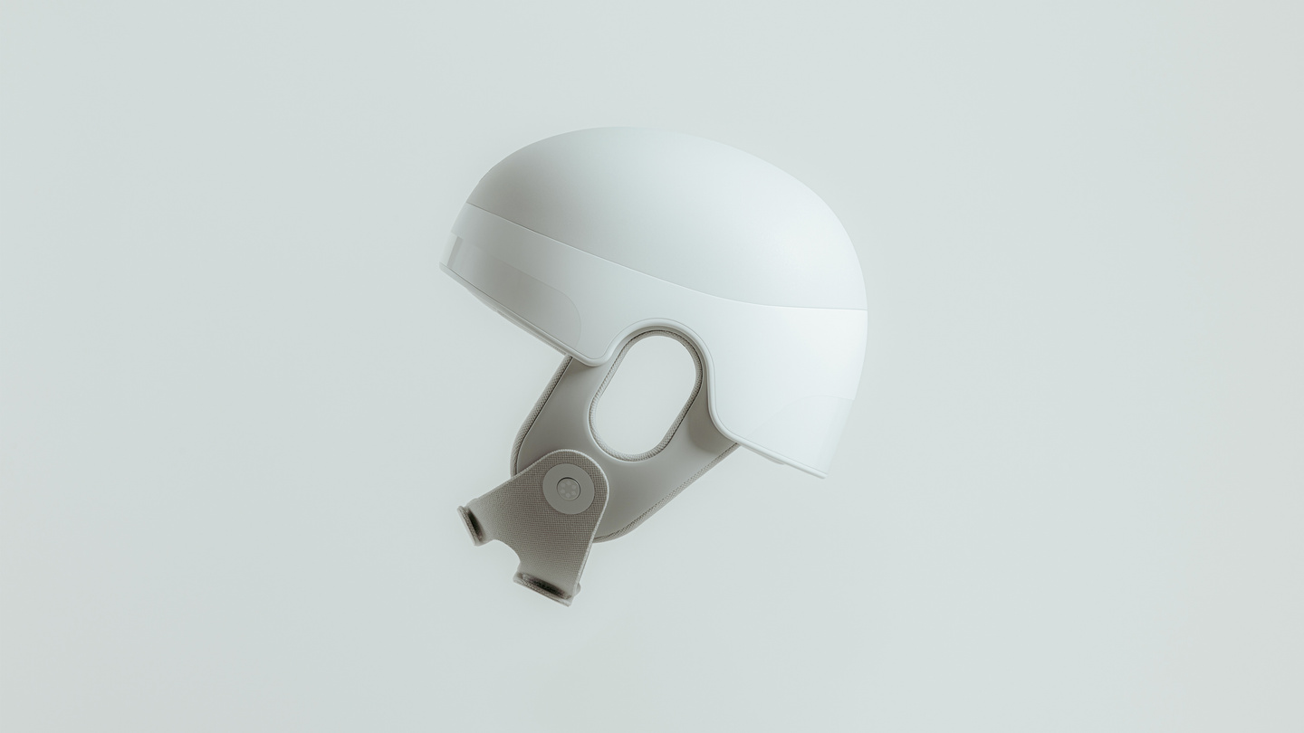 Studio render of a white medical wearable helmet tilted on a plain backdrop