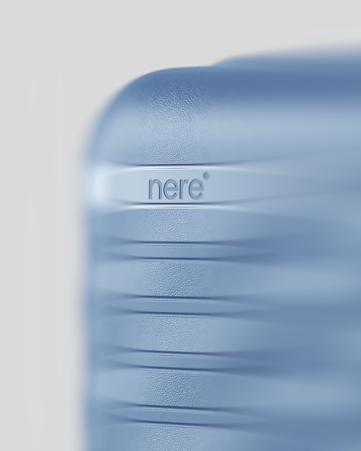 Close-up view of debossed logo on a light blue hardshell suitcase shell