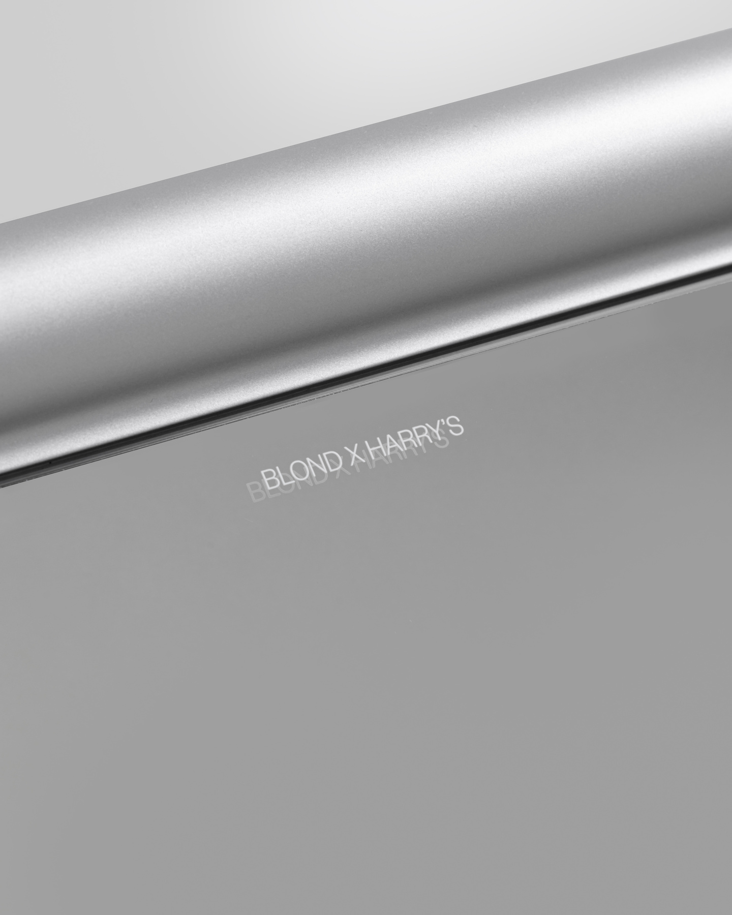 Close-up view of subtle text engraved into a brushed metallic surface