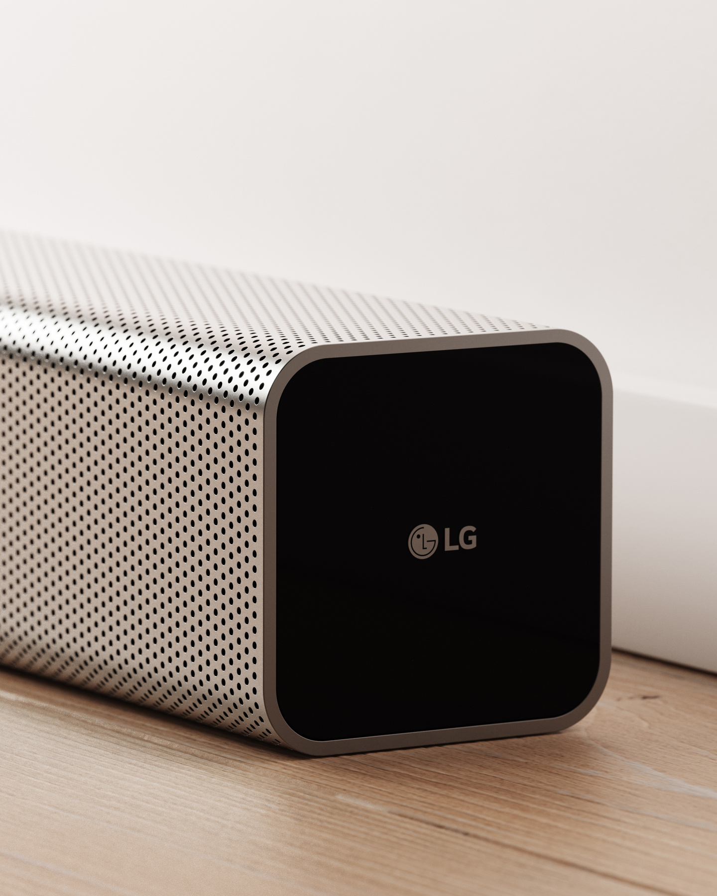 Compact grey speaker unit positioned on a floor surface.