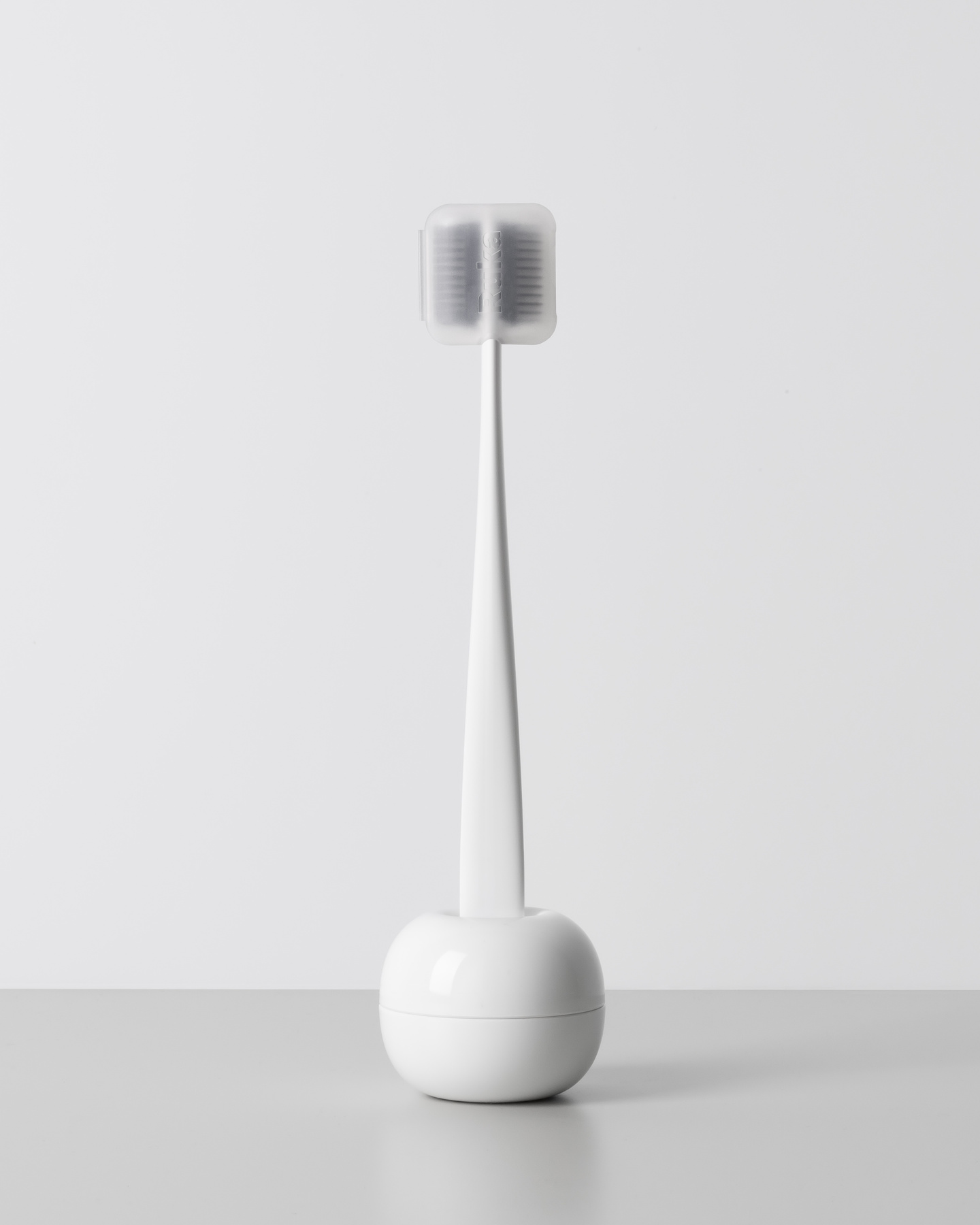 White hair styling tool positioned vertically in a round base
