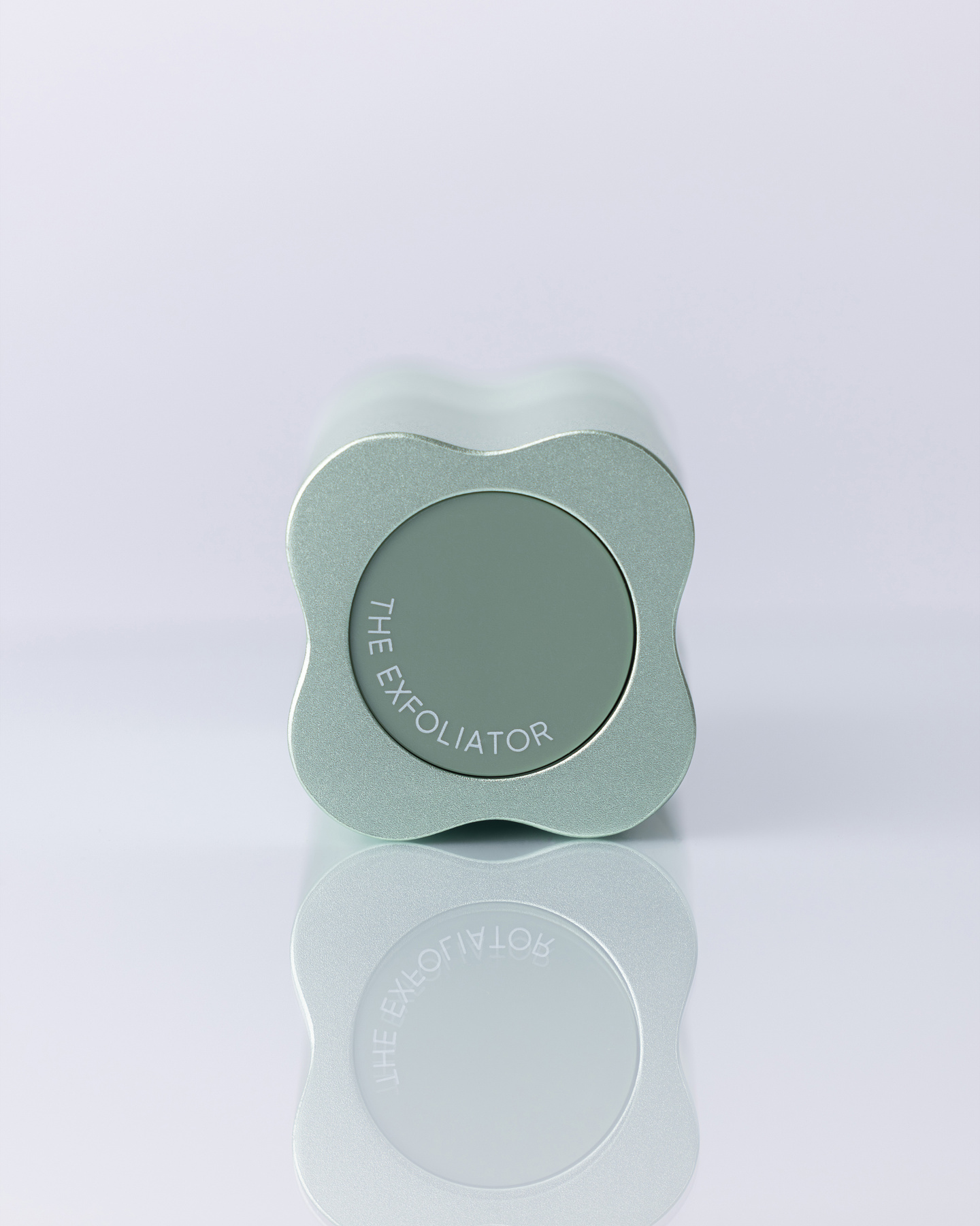 Top-down view of a clover-shaped light green bottle cap