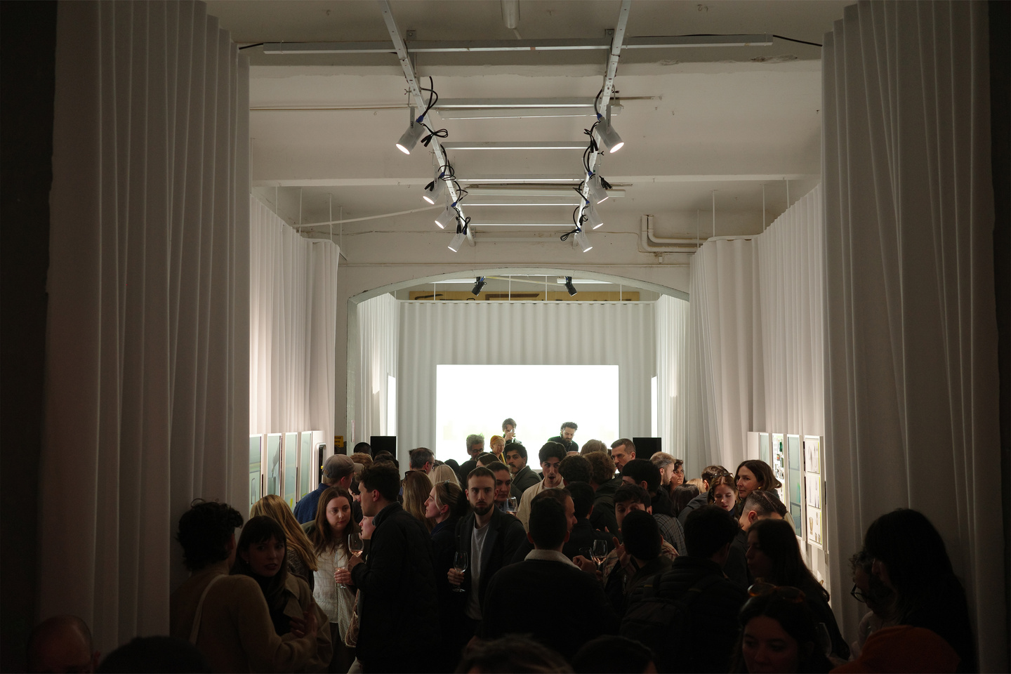 Guests filling main exhibition room during Milan Design Week showcase