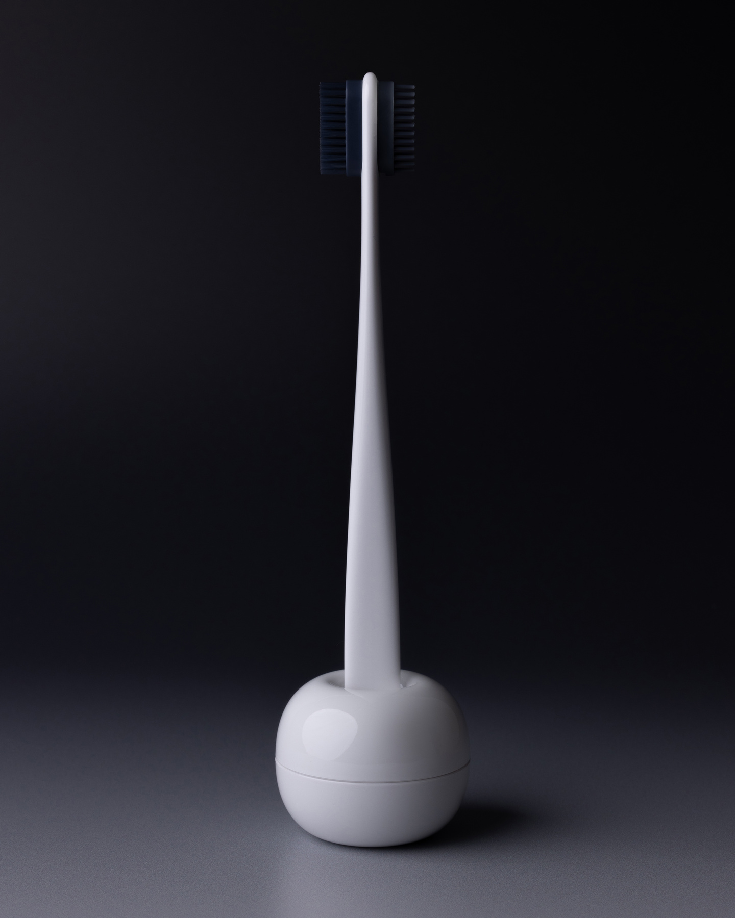 White hair styling tool standing upright in a rounded base on a grey surface