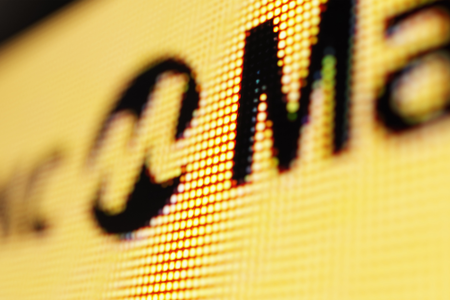 Detailed view of black lettering printed on a yellow illuminated taxi sign