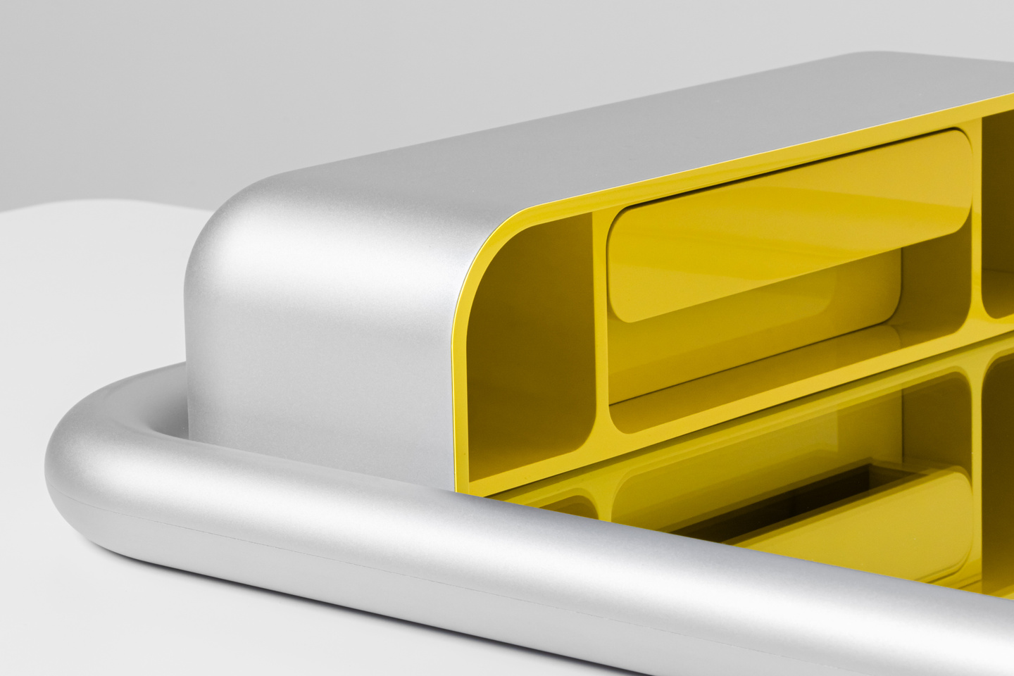 Perspective render showing the lower yellow insert tray of a wall-mounted unit