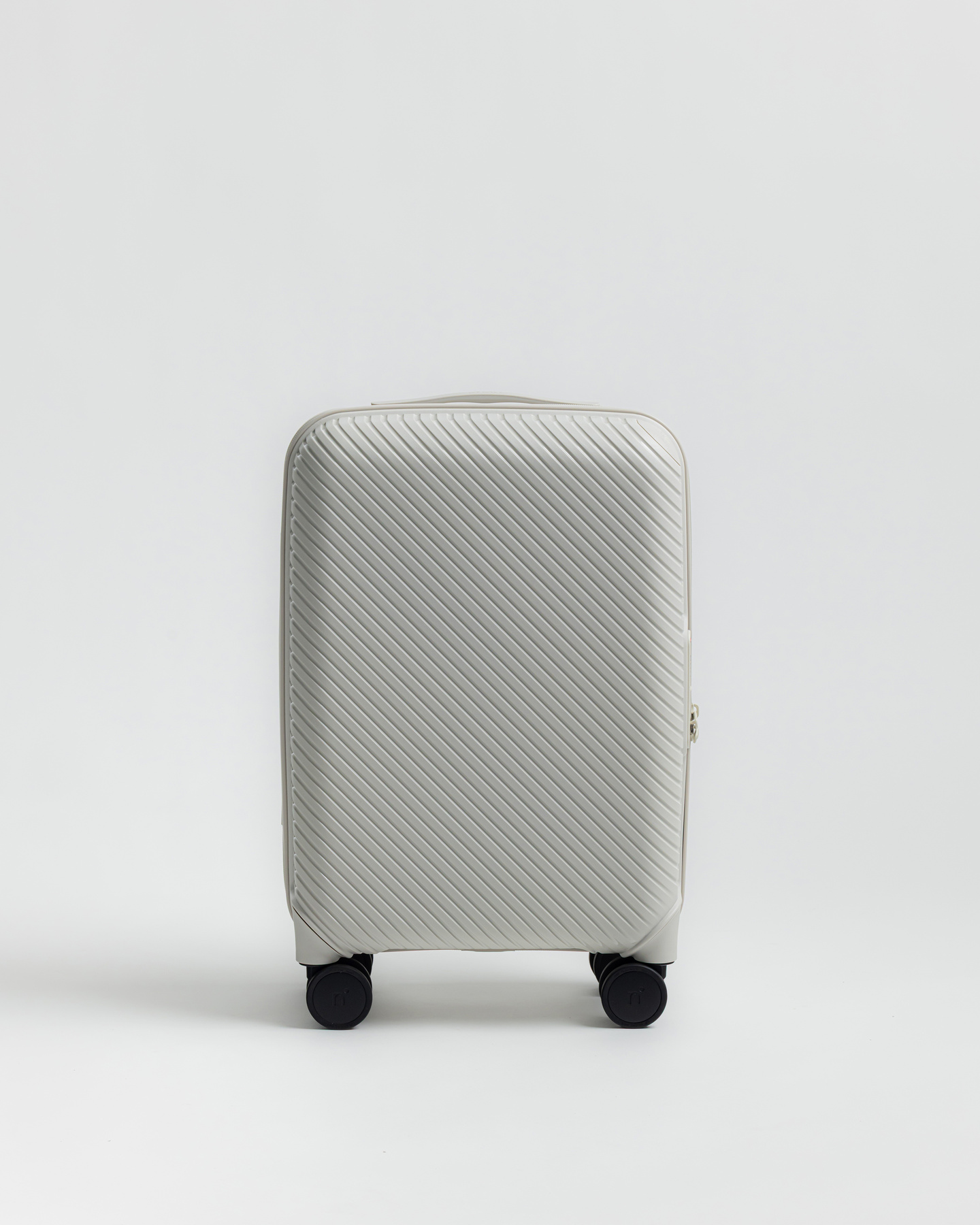 Grey hardshell carry-on suitcase standing against a plain background
