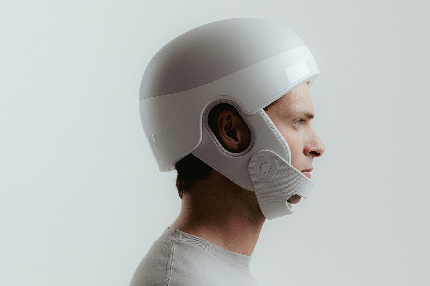 Small profile photo of a person wearing a white wearable medical device