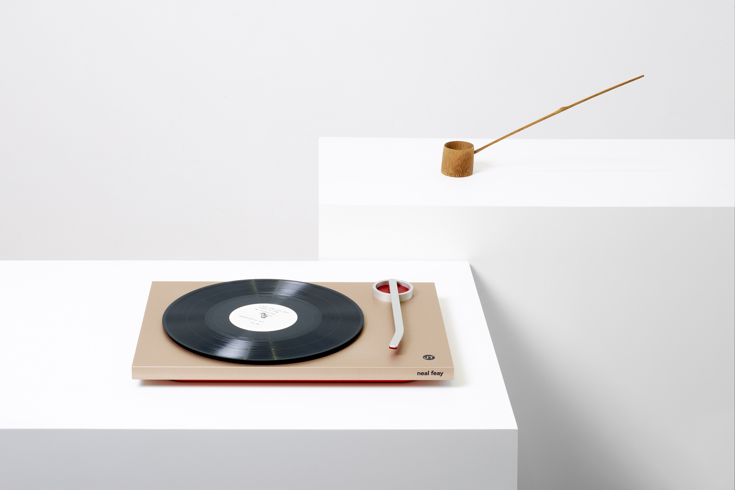 Small prototype object resting on low white display pedestal
