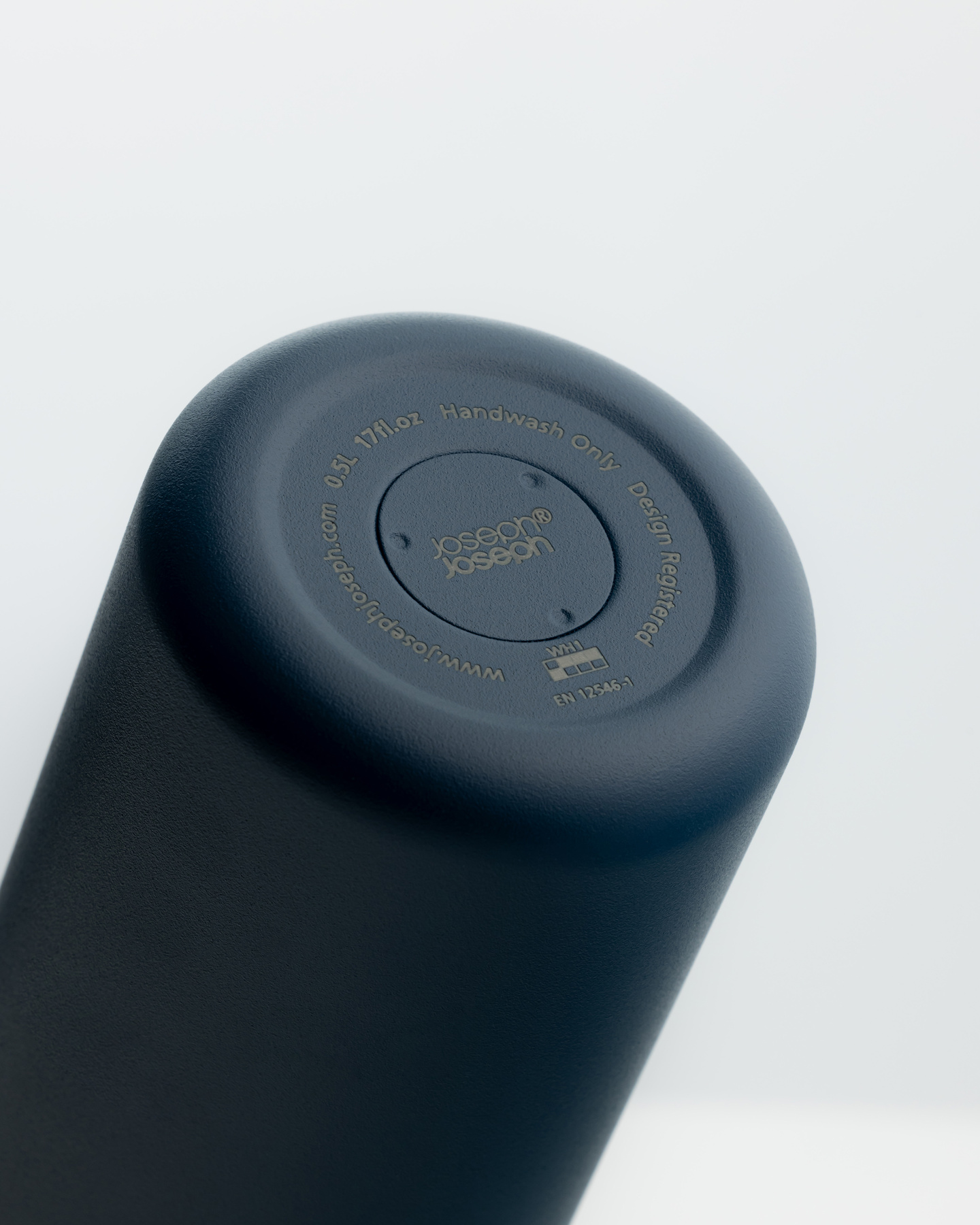 Top-down view of a dark blue bottle on a white background