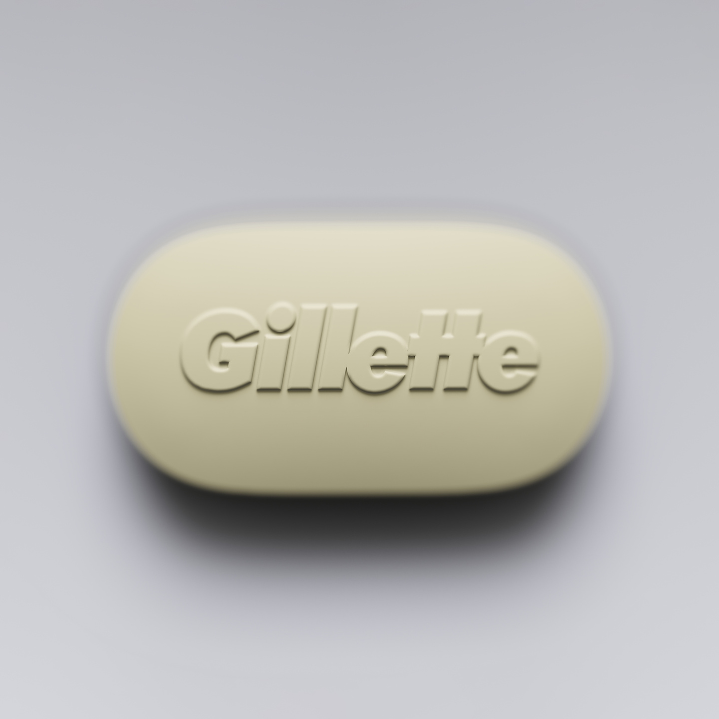Smooth beige oval object embossed with a wordmark on a grey background