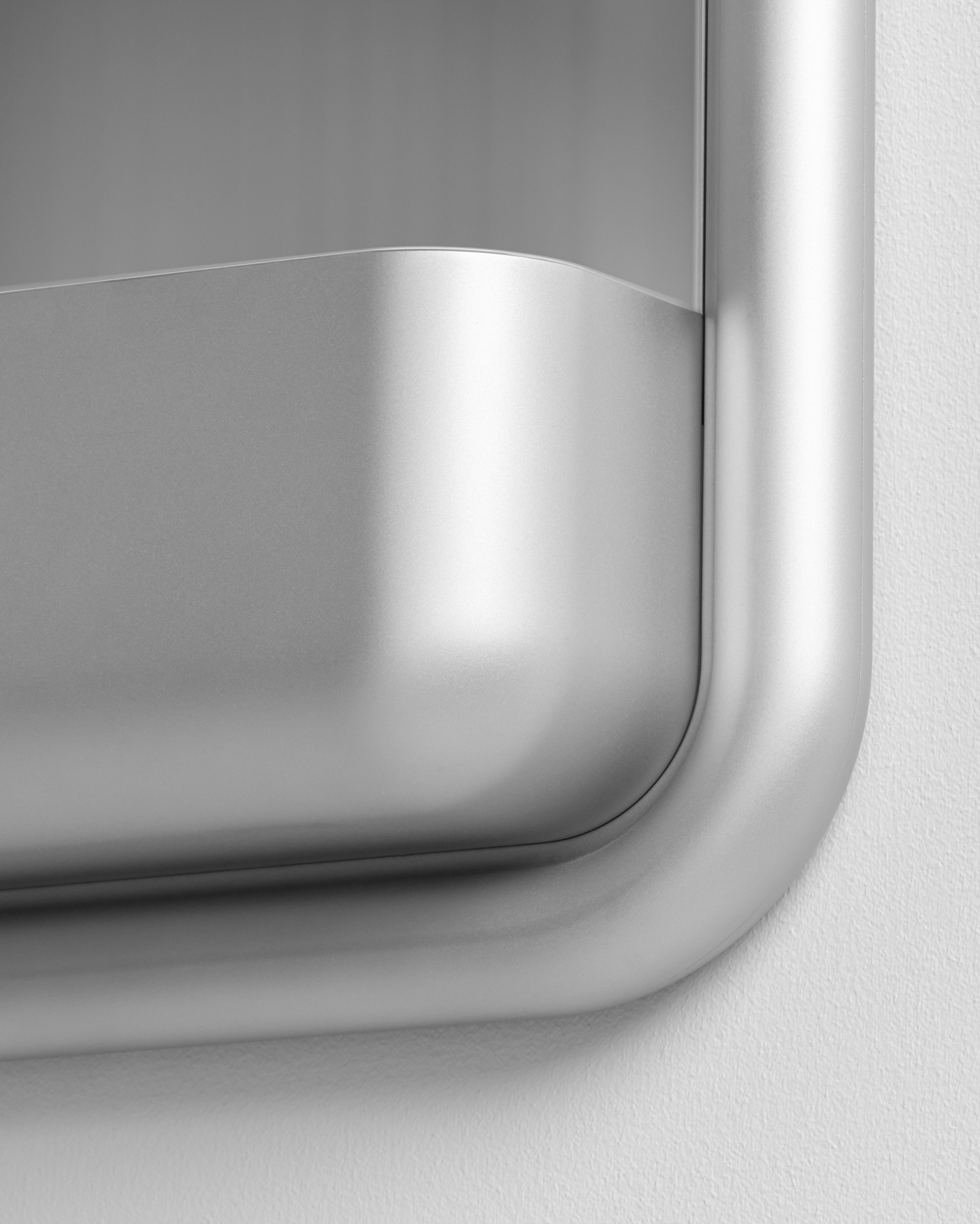 Close-up studio render showing the corner construction of a silver metallic storage tray