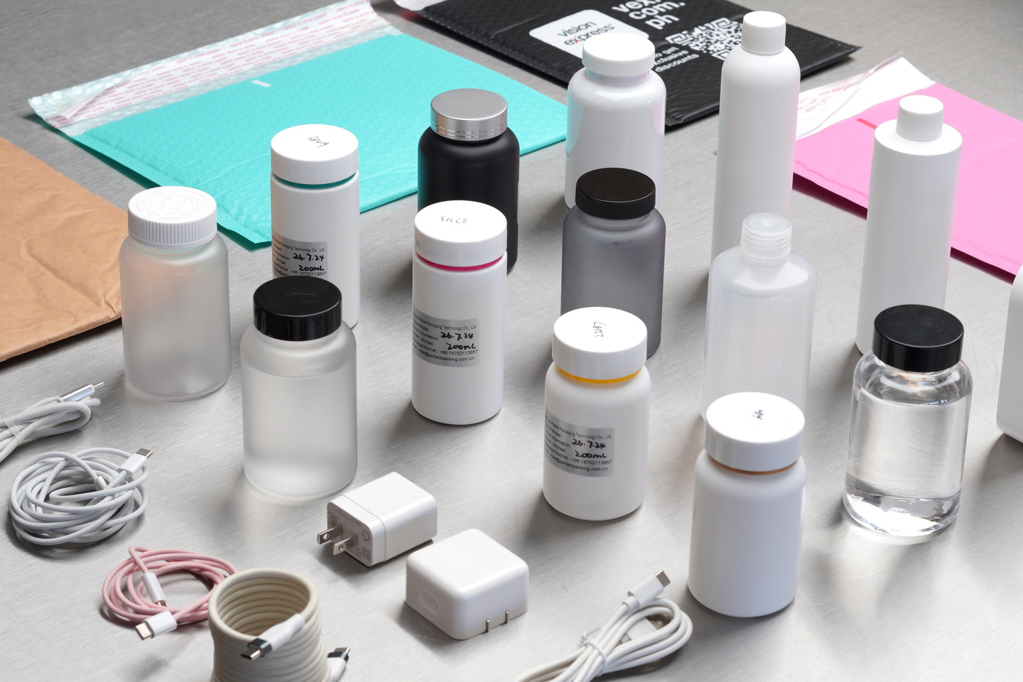 Photographs of many plastic bottles, chargers, and cables sourced for a project.