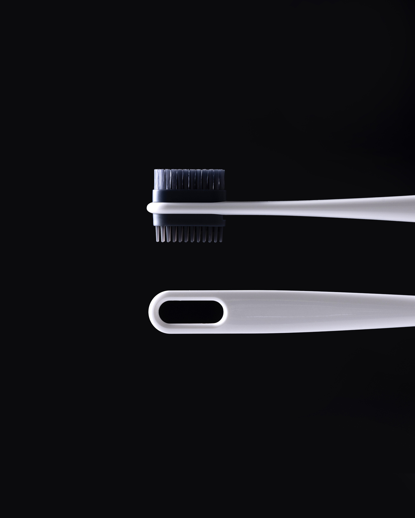 Close-up view of two interchangeable brush and comb attachments
