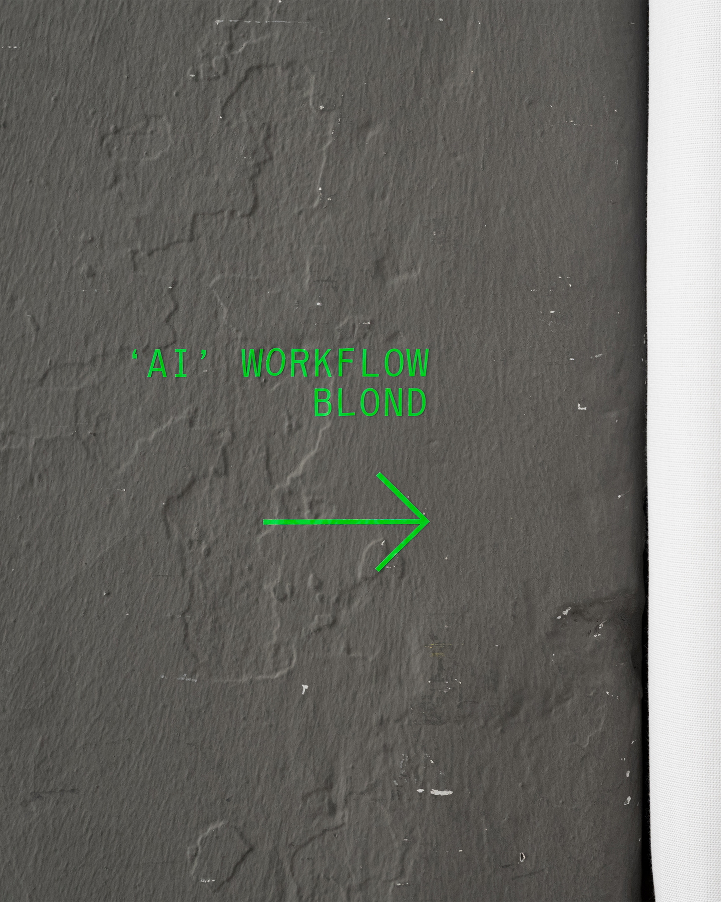 Close-up view of textured asphalt surface with green graphic markings