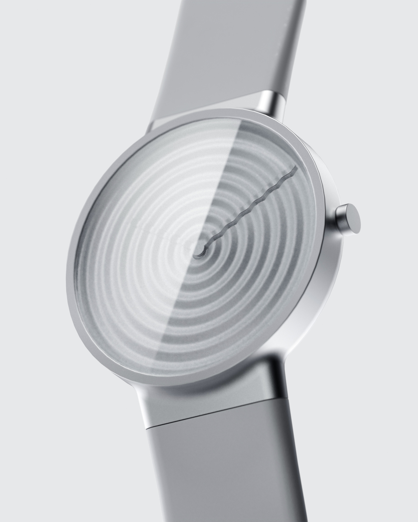 Concentric circular patterned silver wristwatch dial with metallic strap on light background