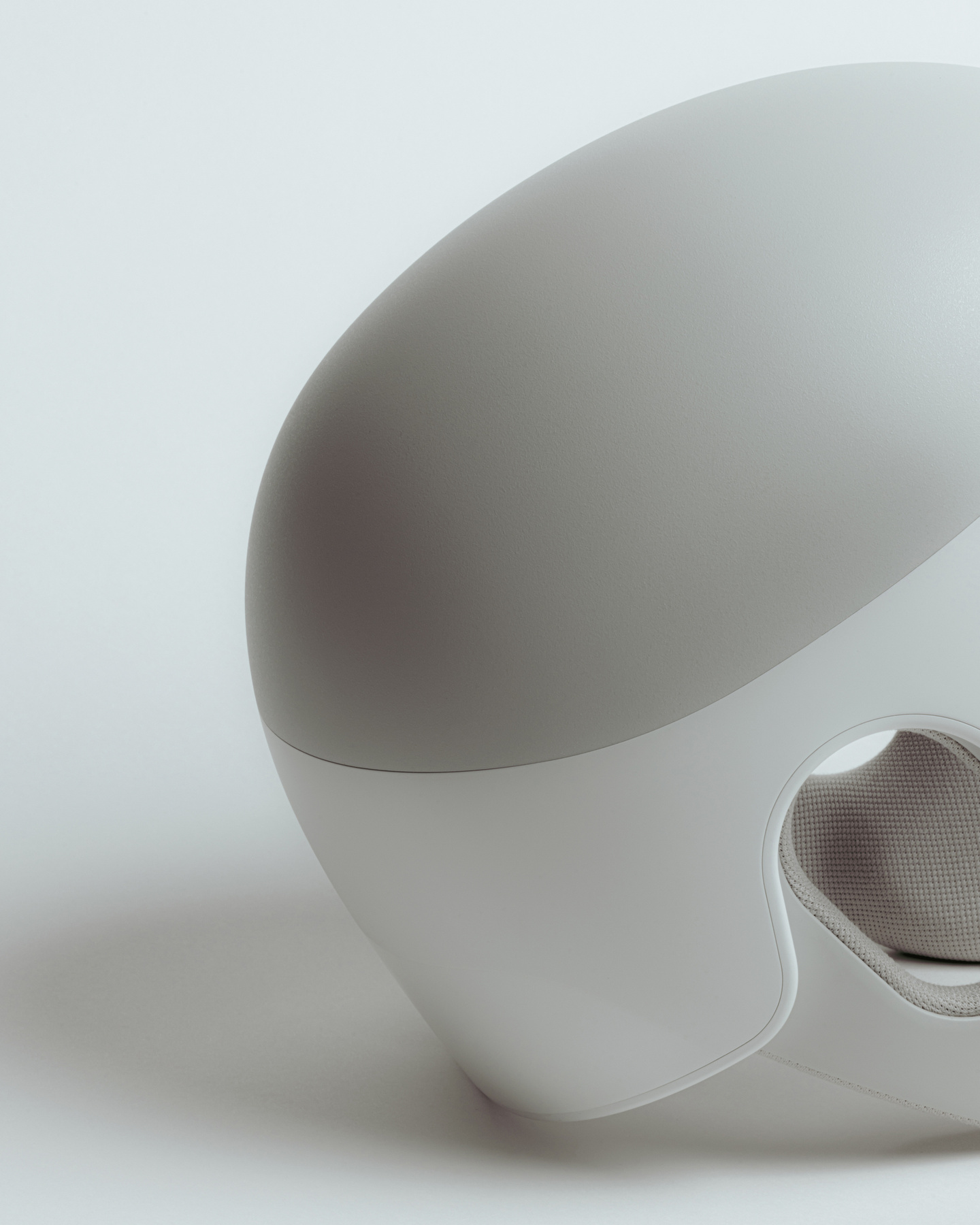 Small studio render of a white medical wearable device on plain background