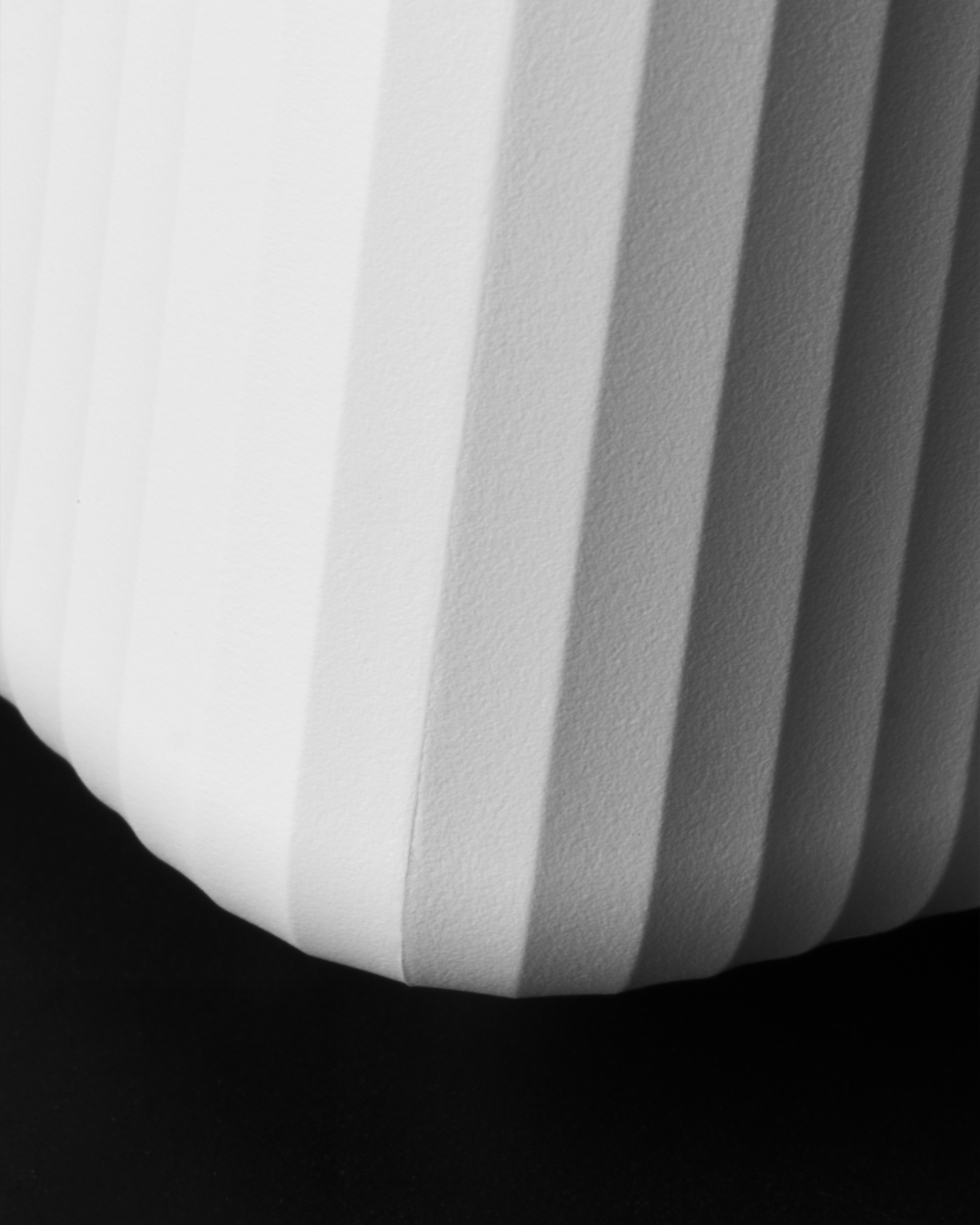 Close-up view of rounded lower corner on ribbed white casing