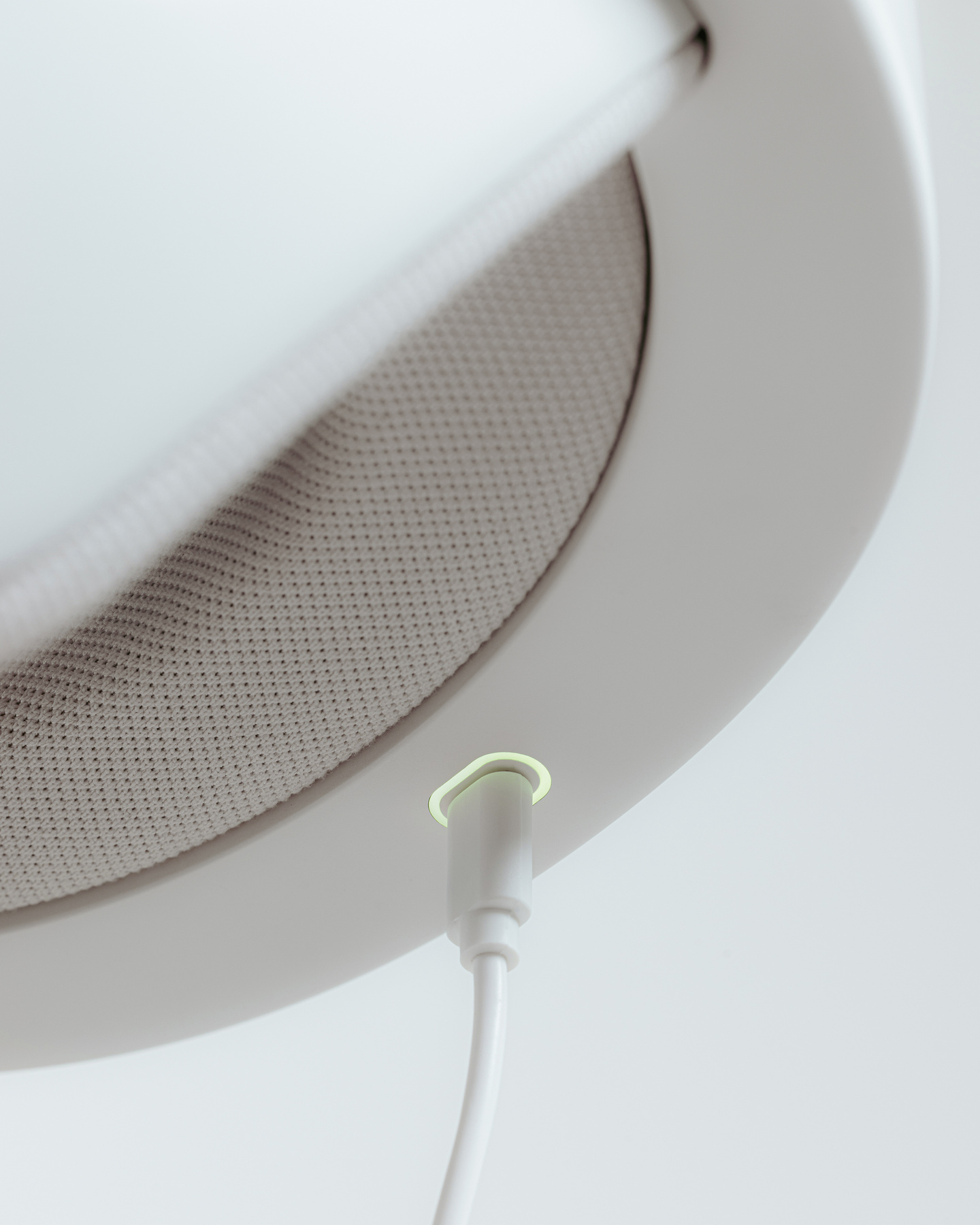Render looking up at the interior lining and charging port of a white helmet device
