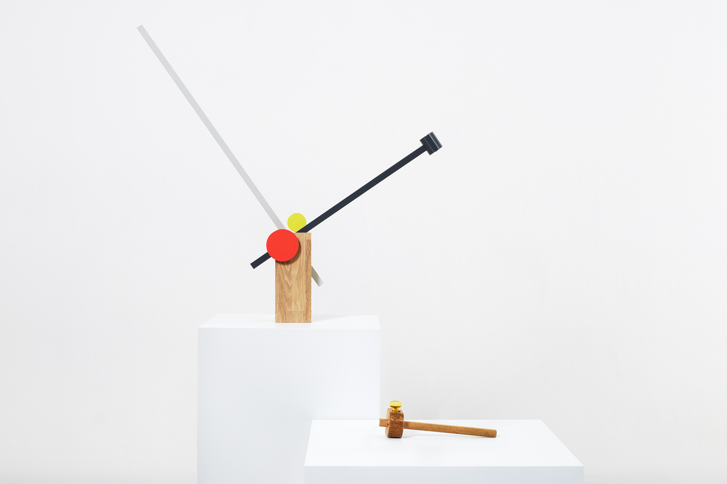 Small prototype fixture resting on low white exhibition plinth