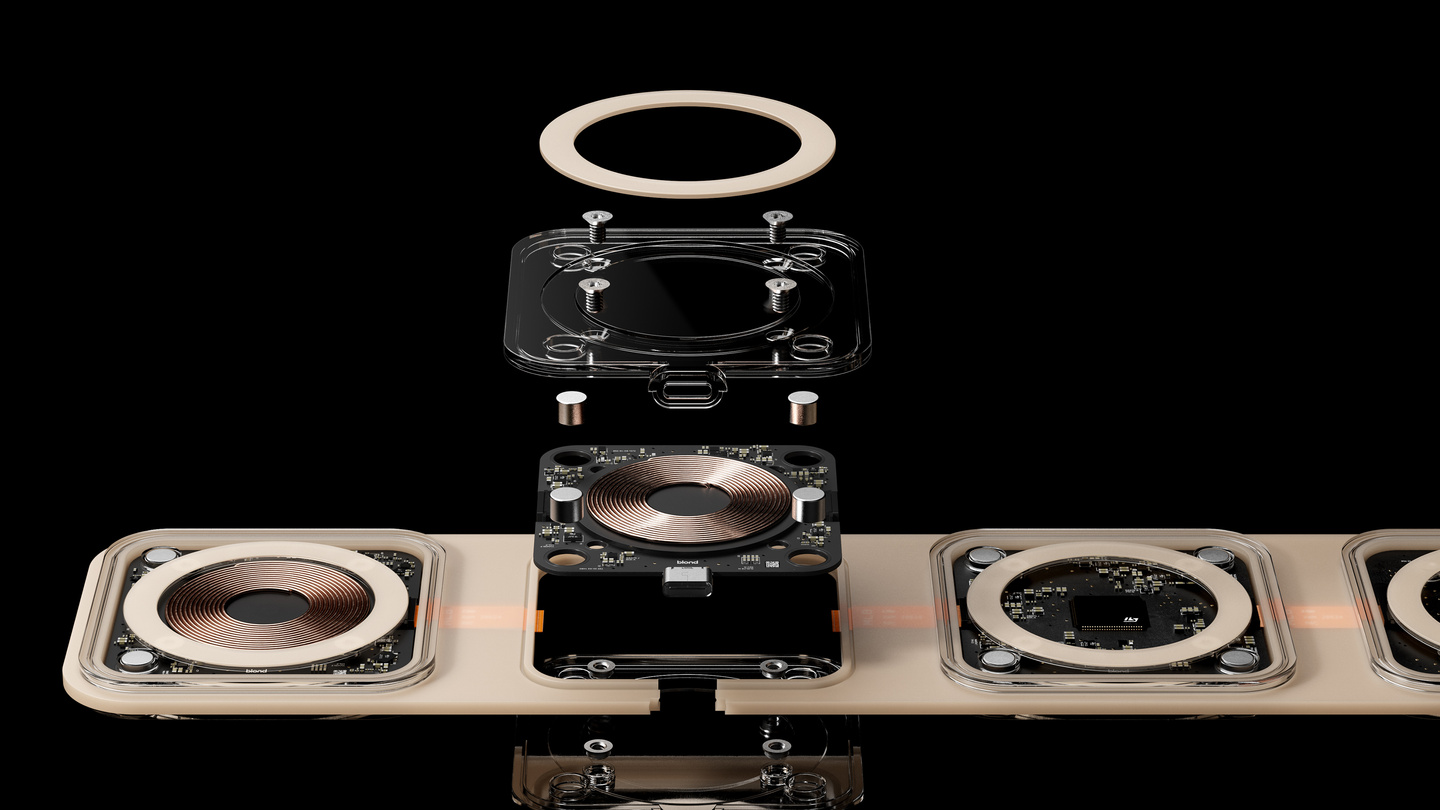 Exploded view showing internal copper induction coils and housing layers of a folding wireless charger.