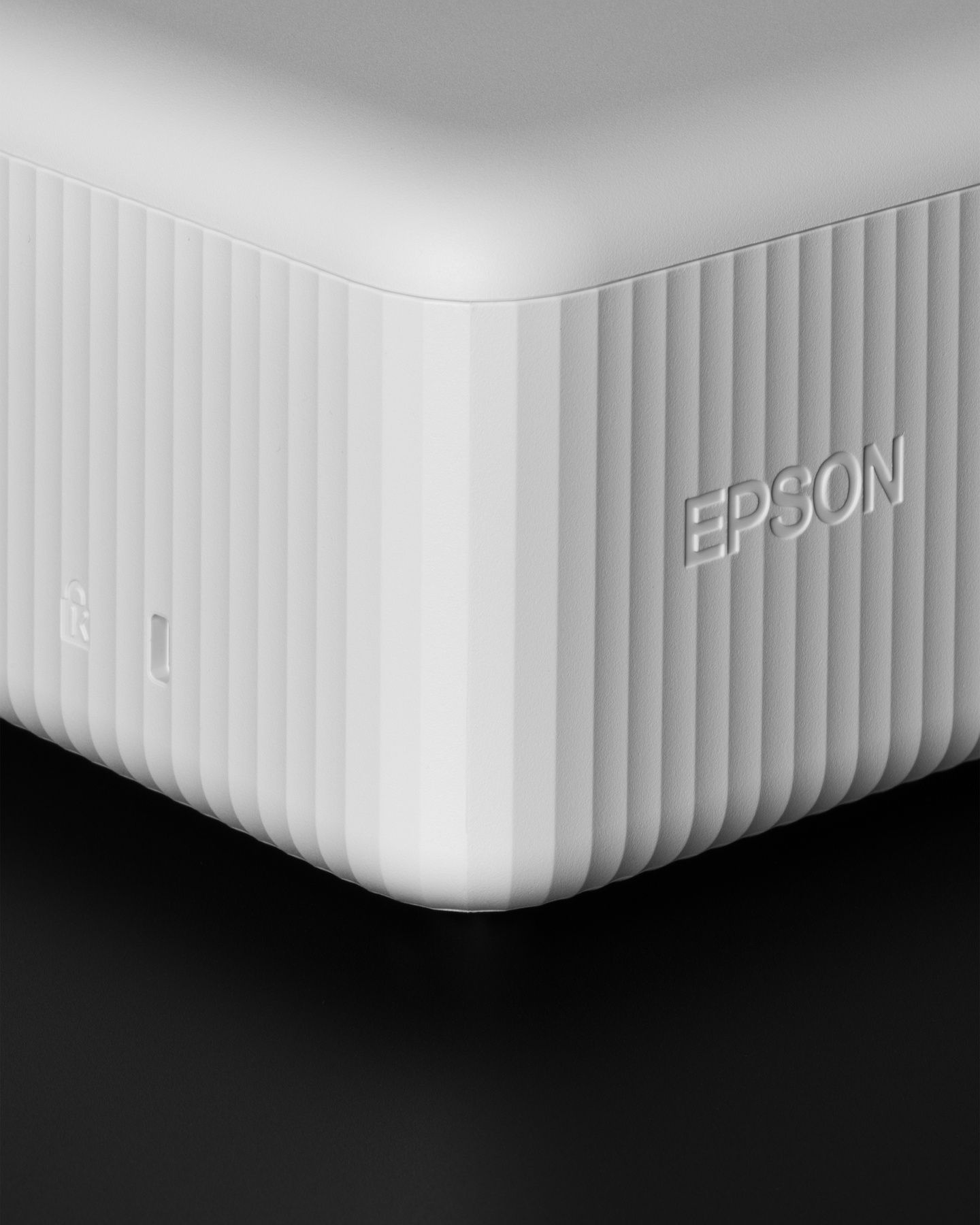 Detailed close-up of top corner and debossed logo on white body