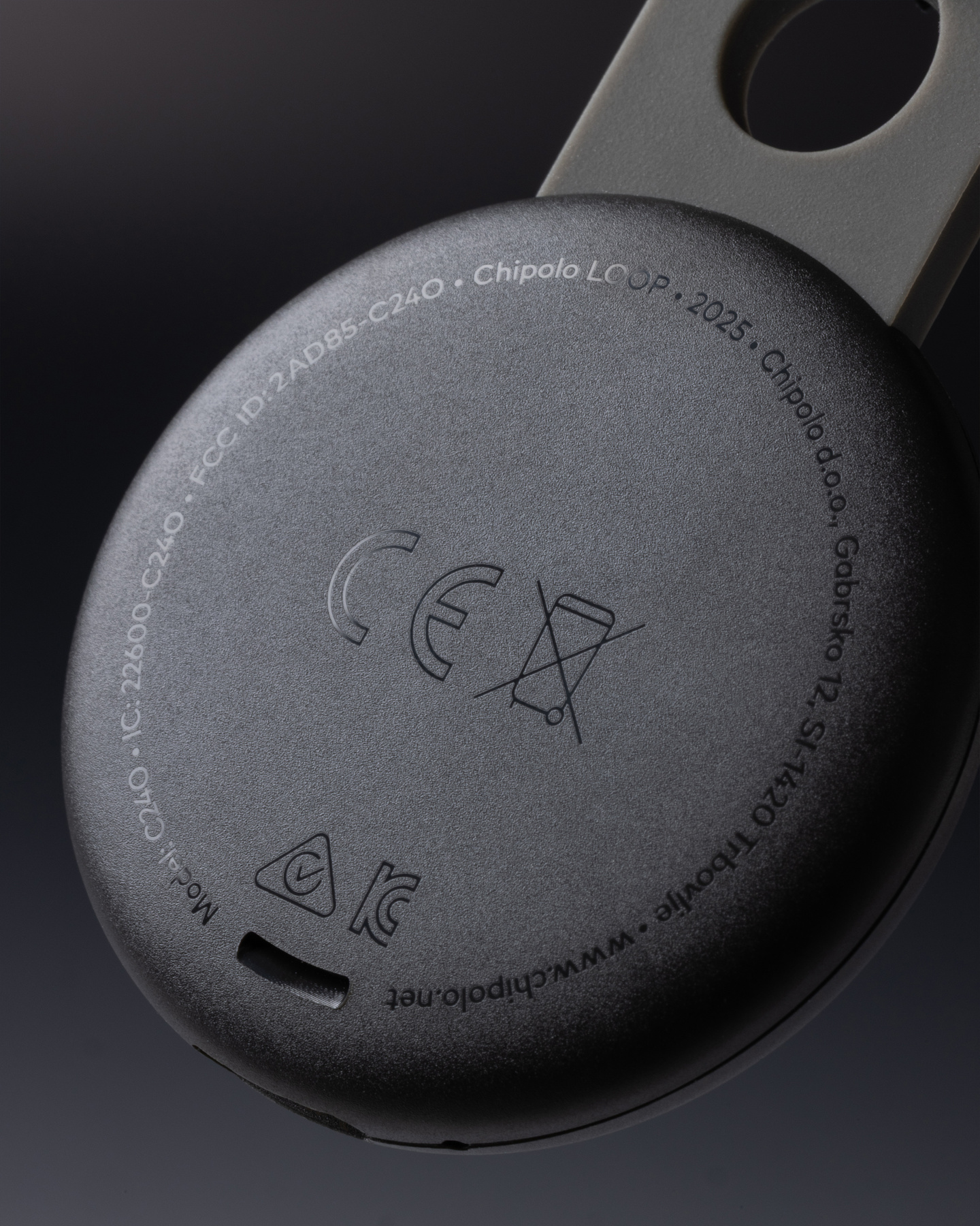 Close-up view of a dark textured circular tracker loop with embossed details.