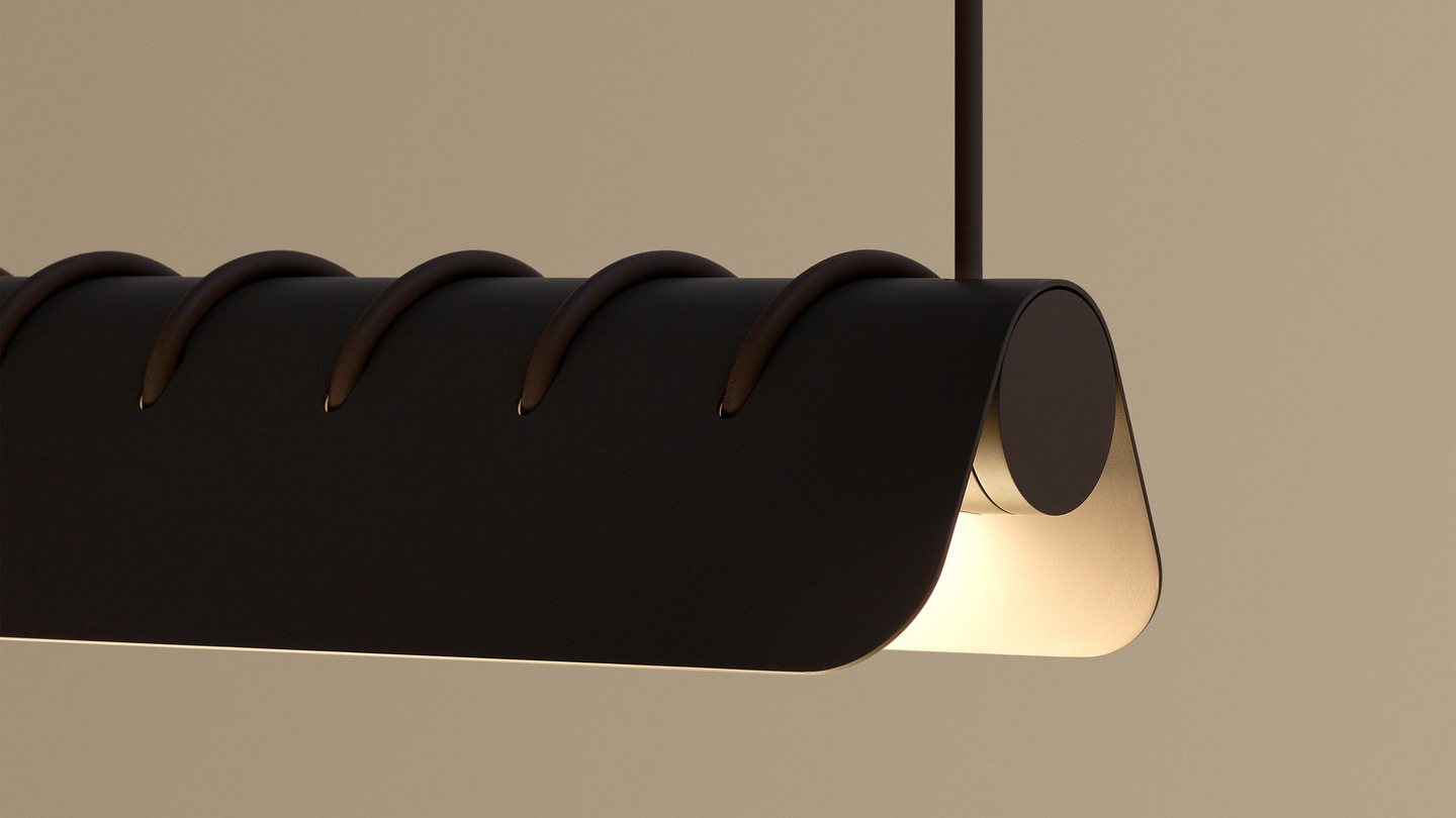 Illuminated dark spiral pendant lamp suspended against a warm background.