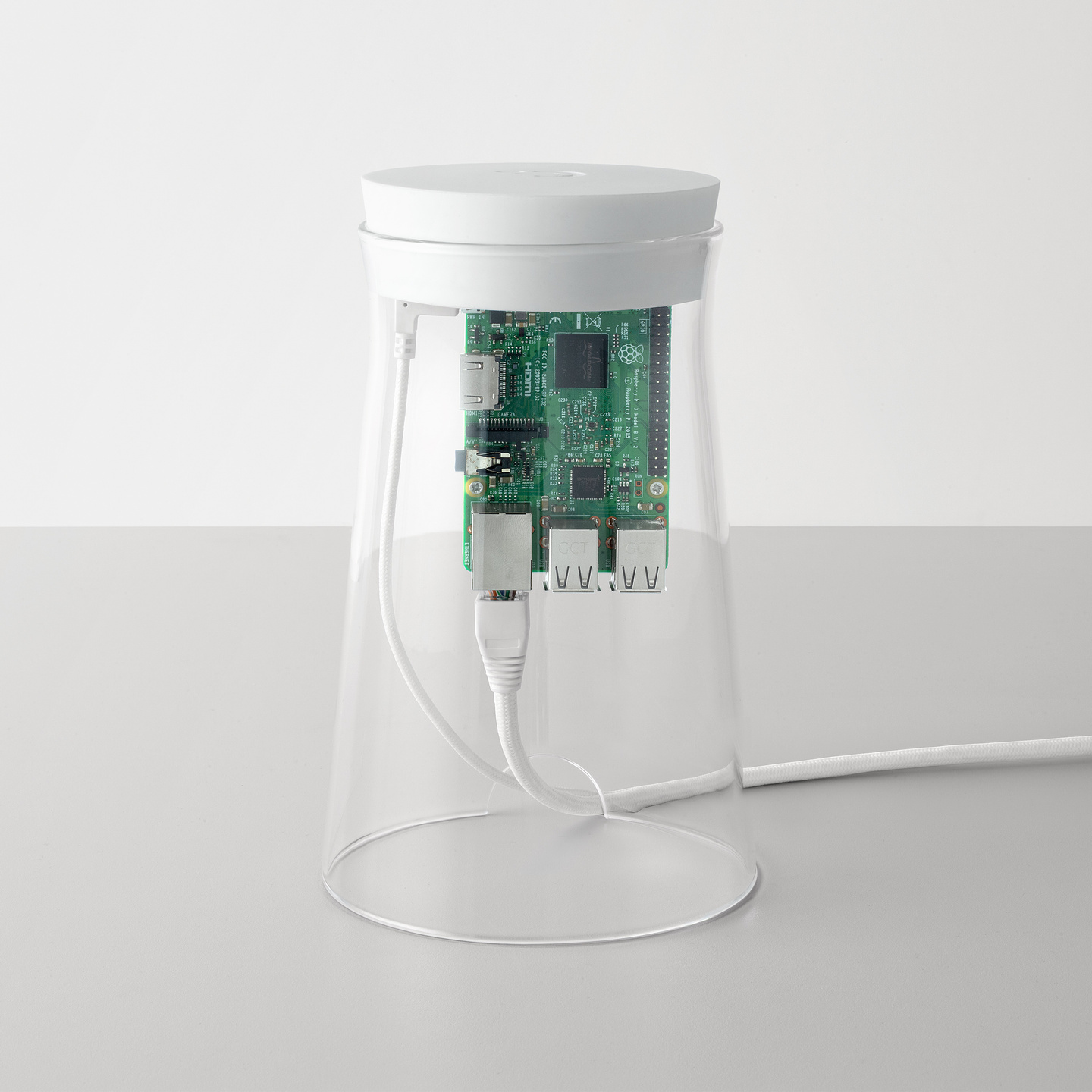Hand lifting the top cap and internal circuit board from a glass cylinder unit.