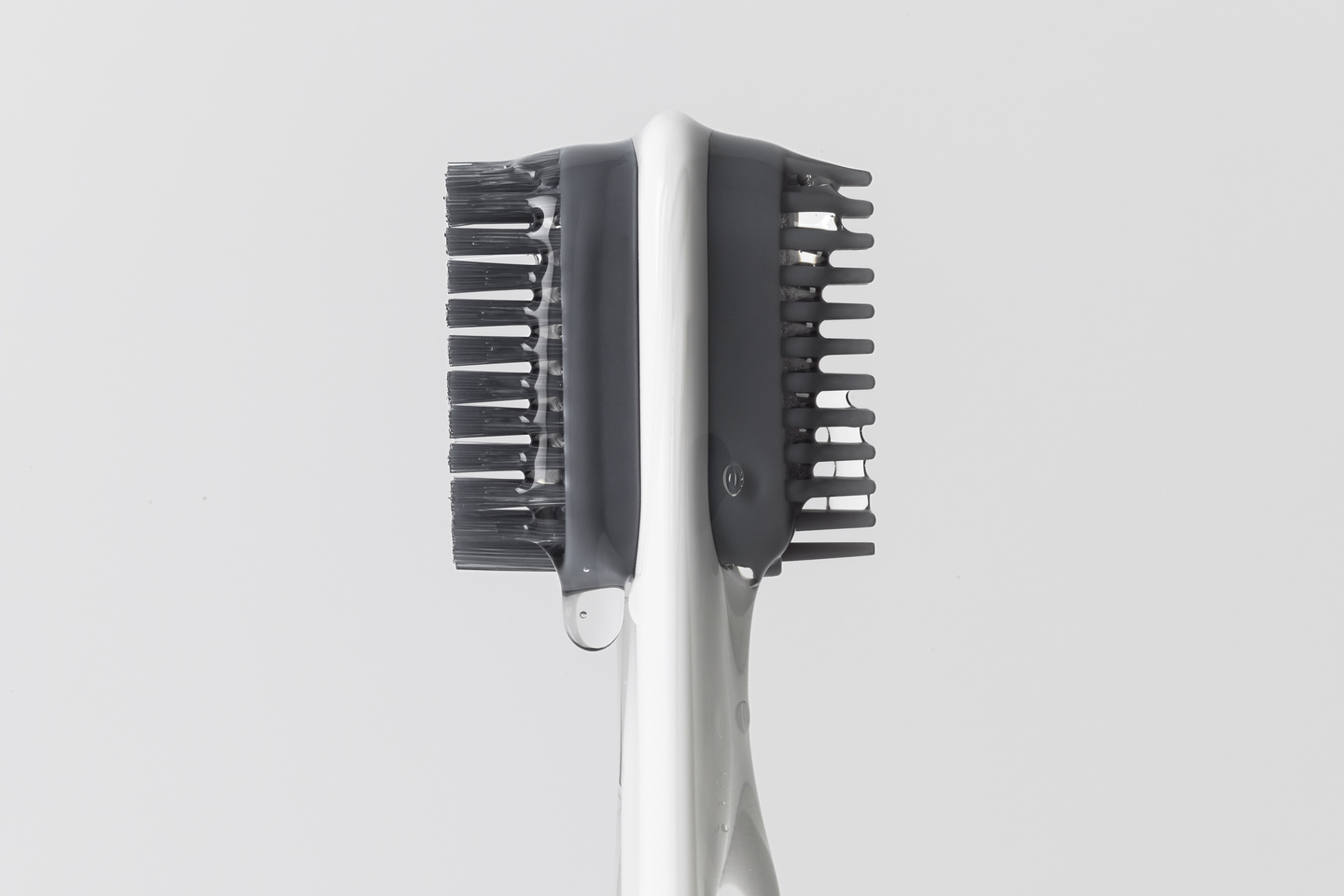 Close-up detail of a fine-toothed comb head attachment