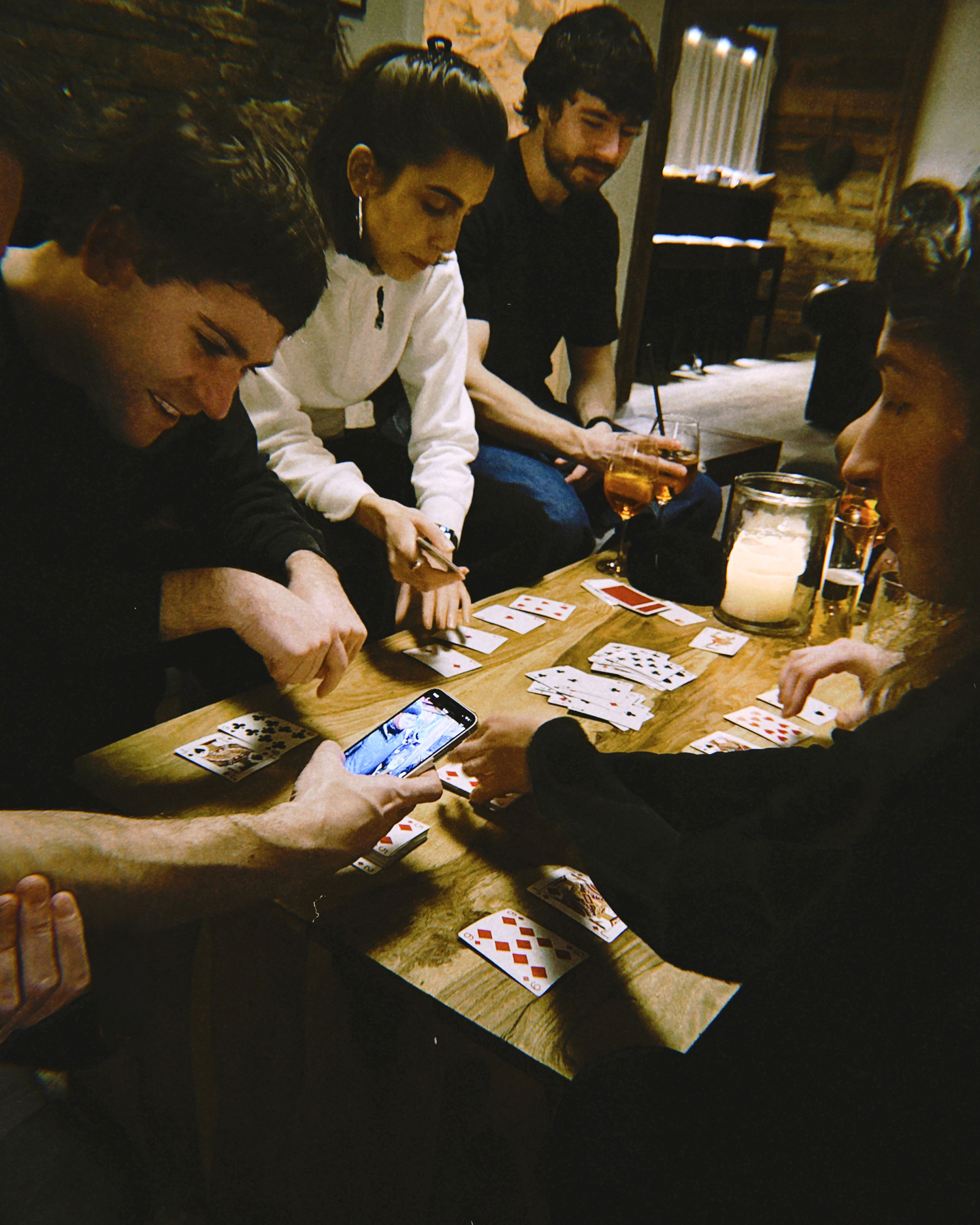 A photograph of a card game between the BLOND's team members during the company ski trip