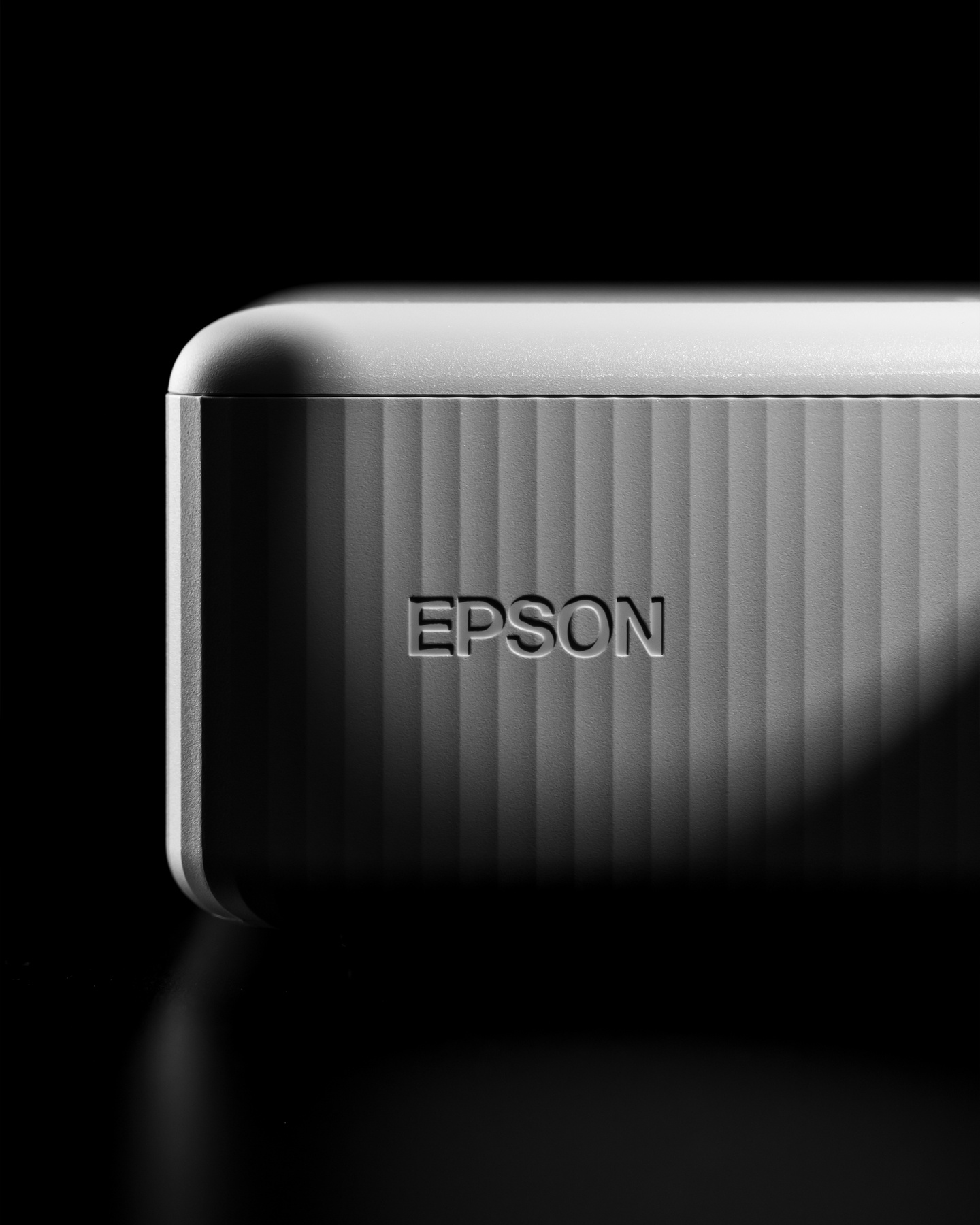 Small close-up view of rounded corner with debossed logo