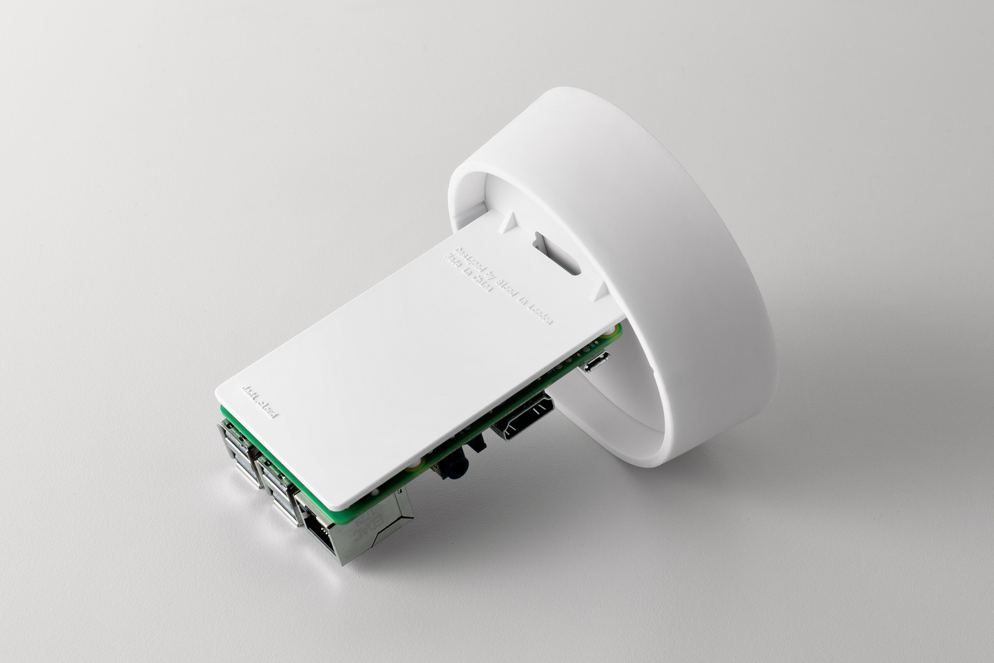 White plastic top component attached to a green printed circuit board.