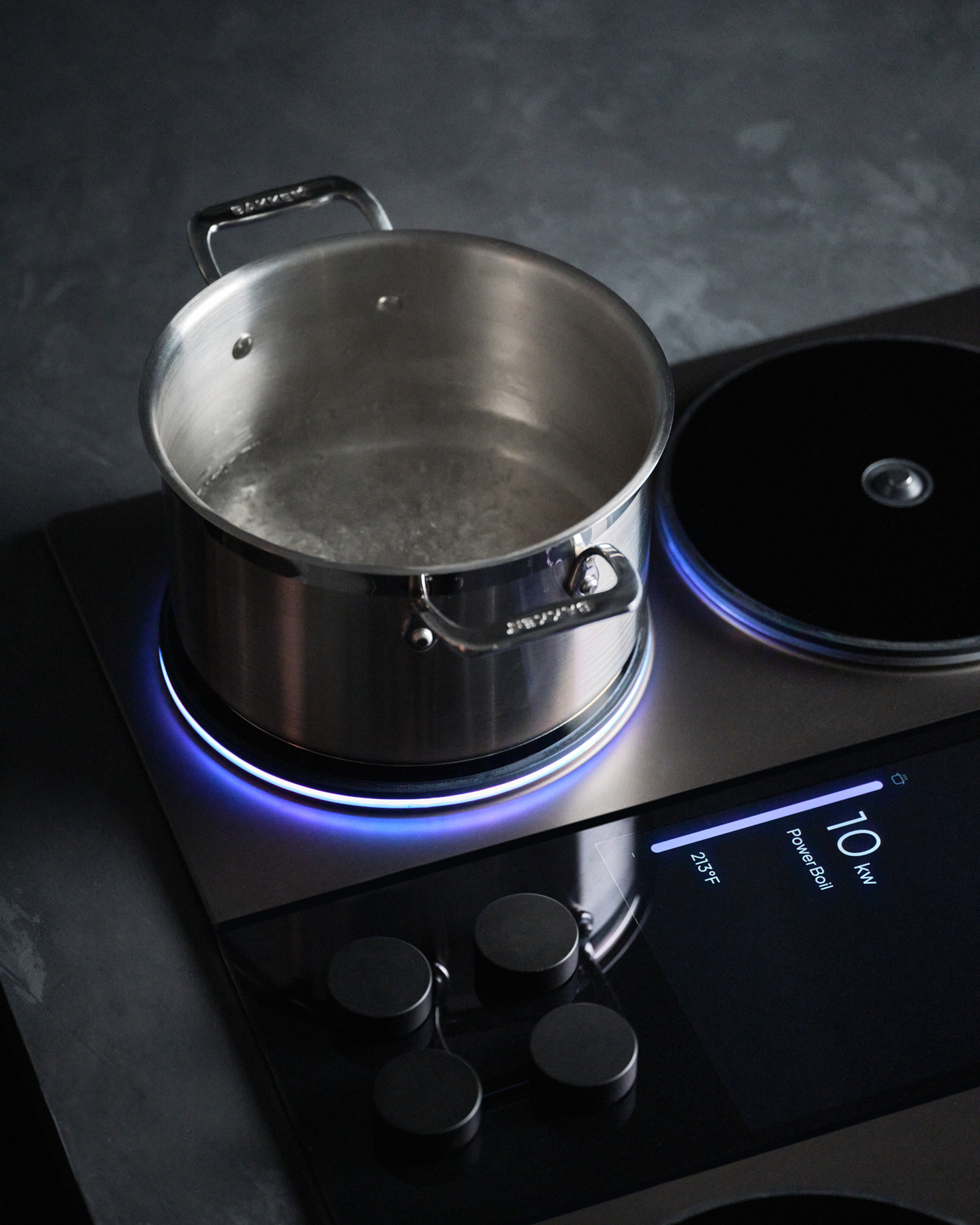 Cookware pan resting on an active induction burner with light ring