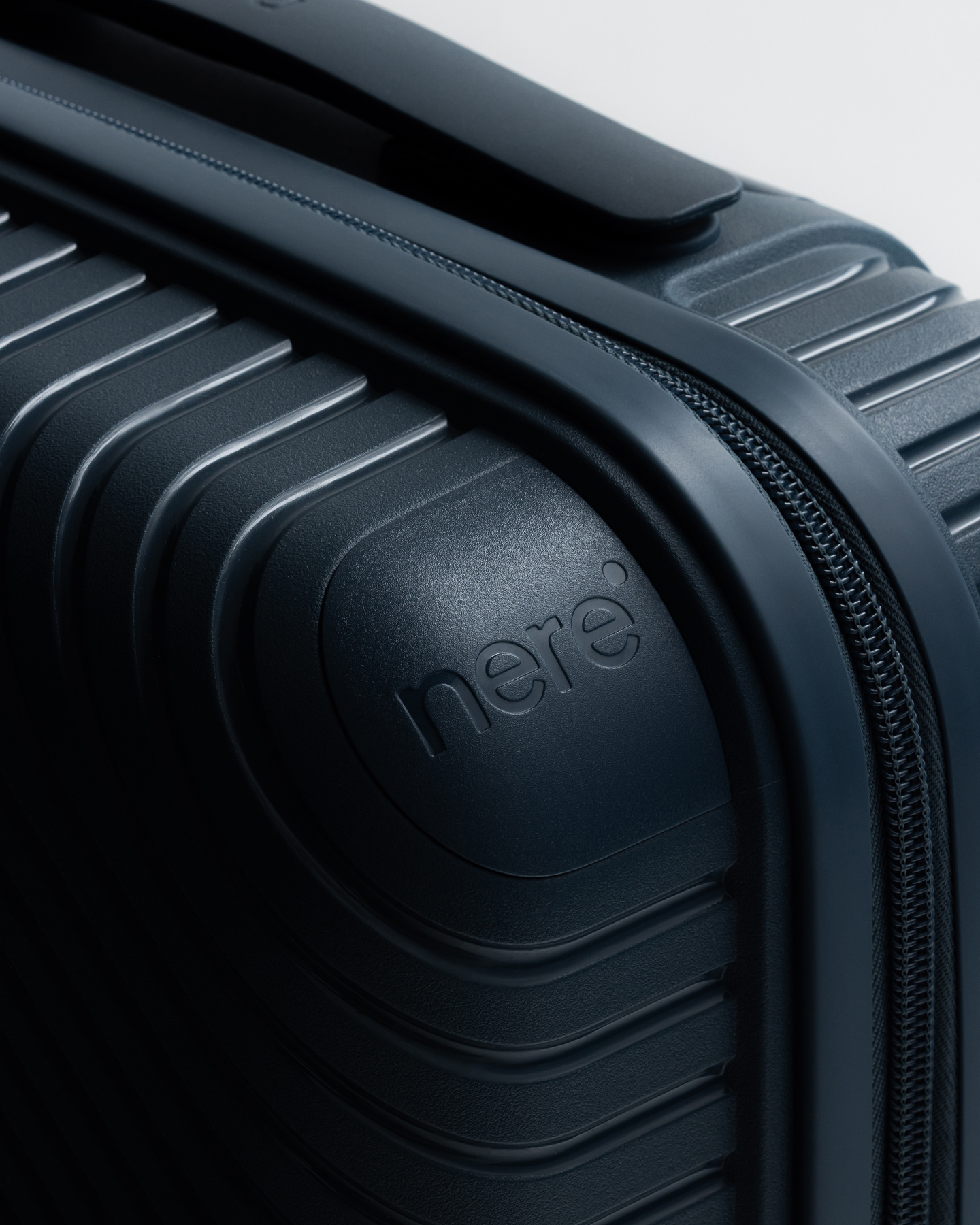 Close-up of textured corner of dark blue hardhsell suitcase