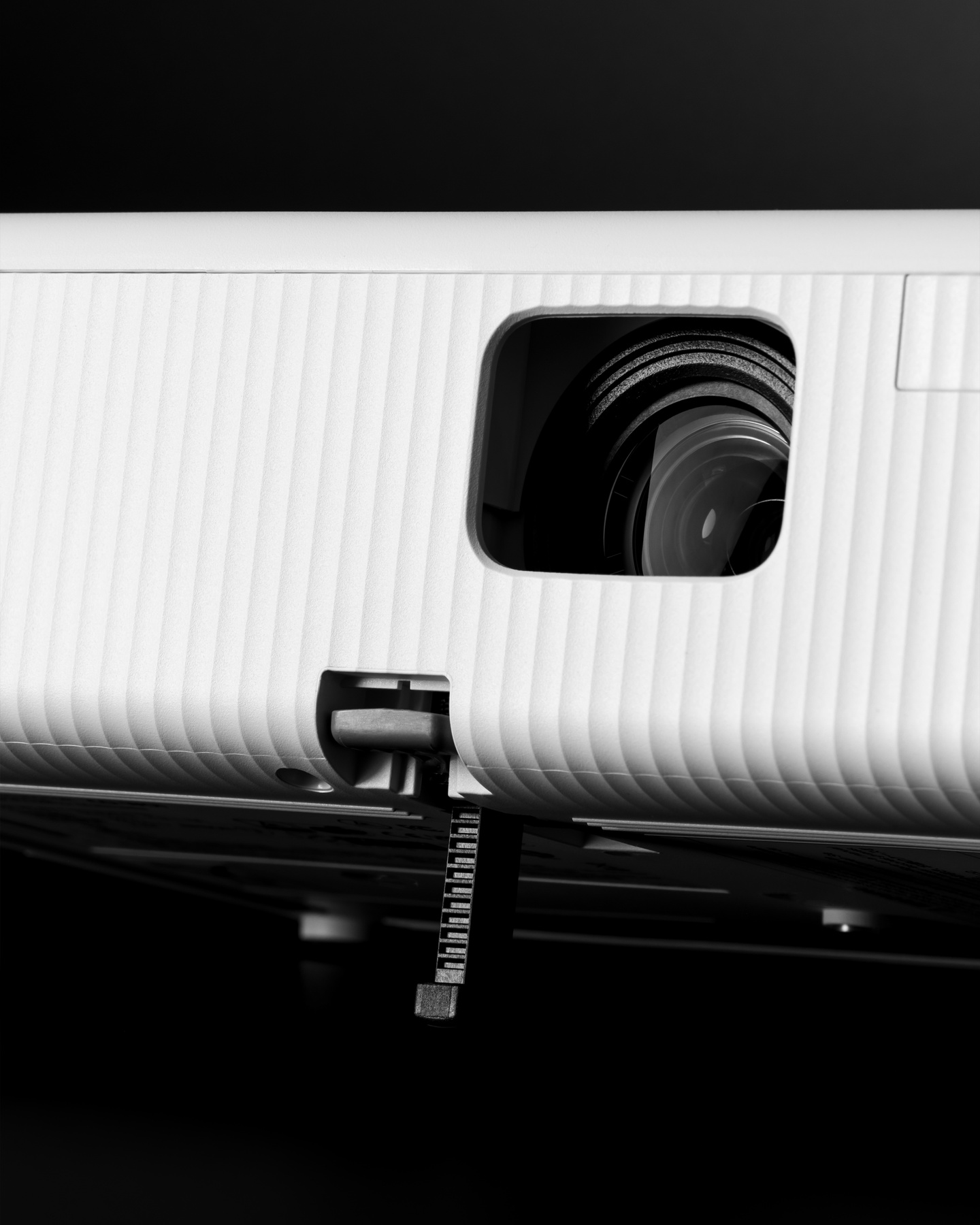 Close-up view of a projector lens and ribbed outer casing