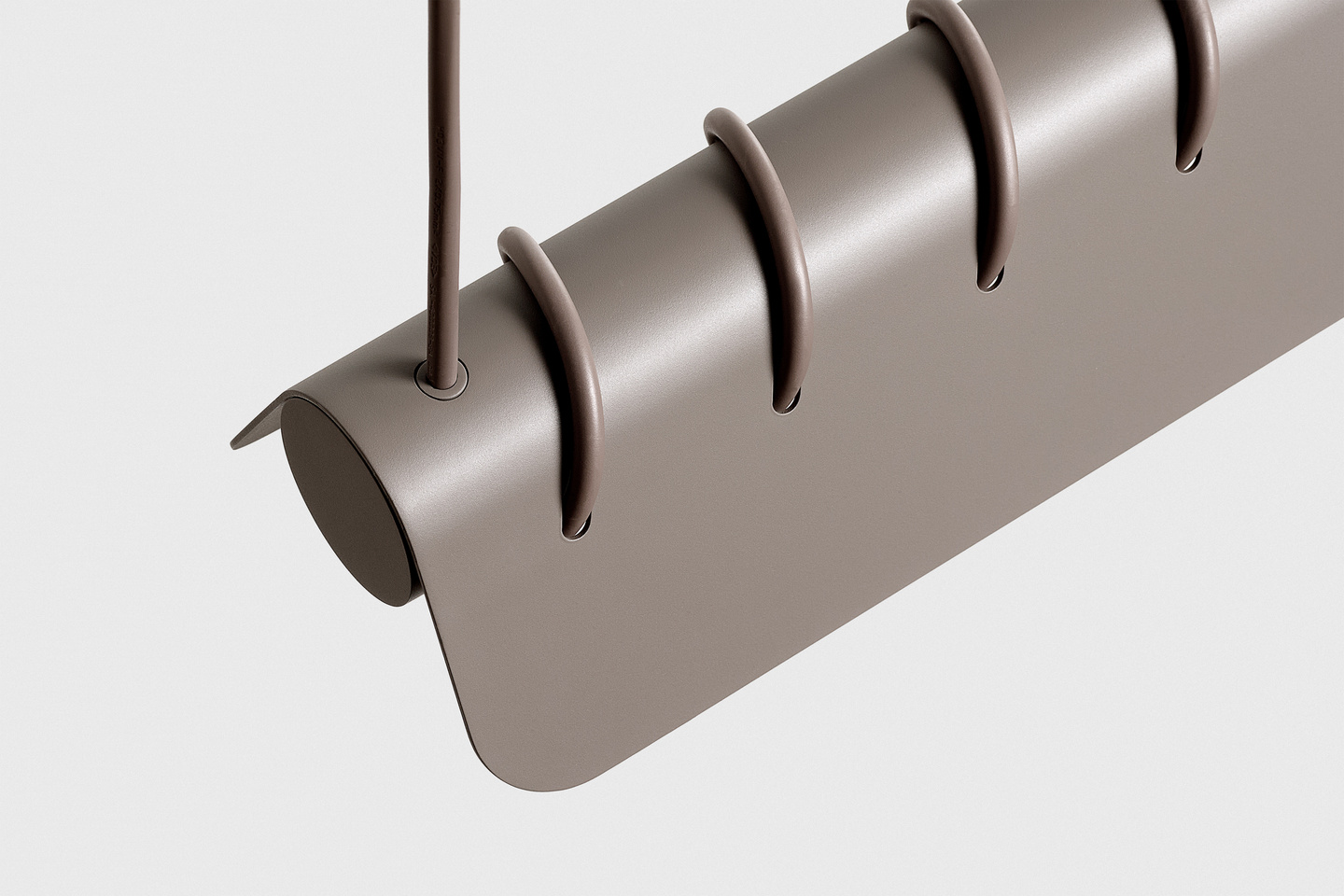 Close-up angled view of a grey slotted lamp shade attached to a suspension cable.
