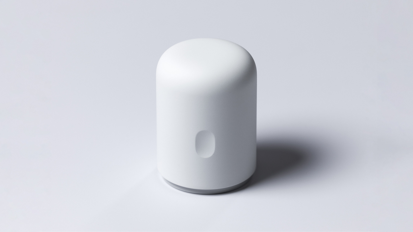 Matte white cylindrical continuous glucose monitor applicator standing upright on a neutral background